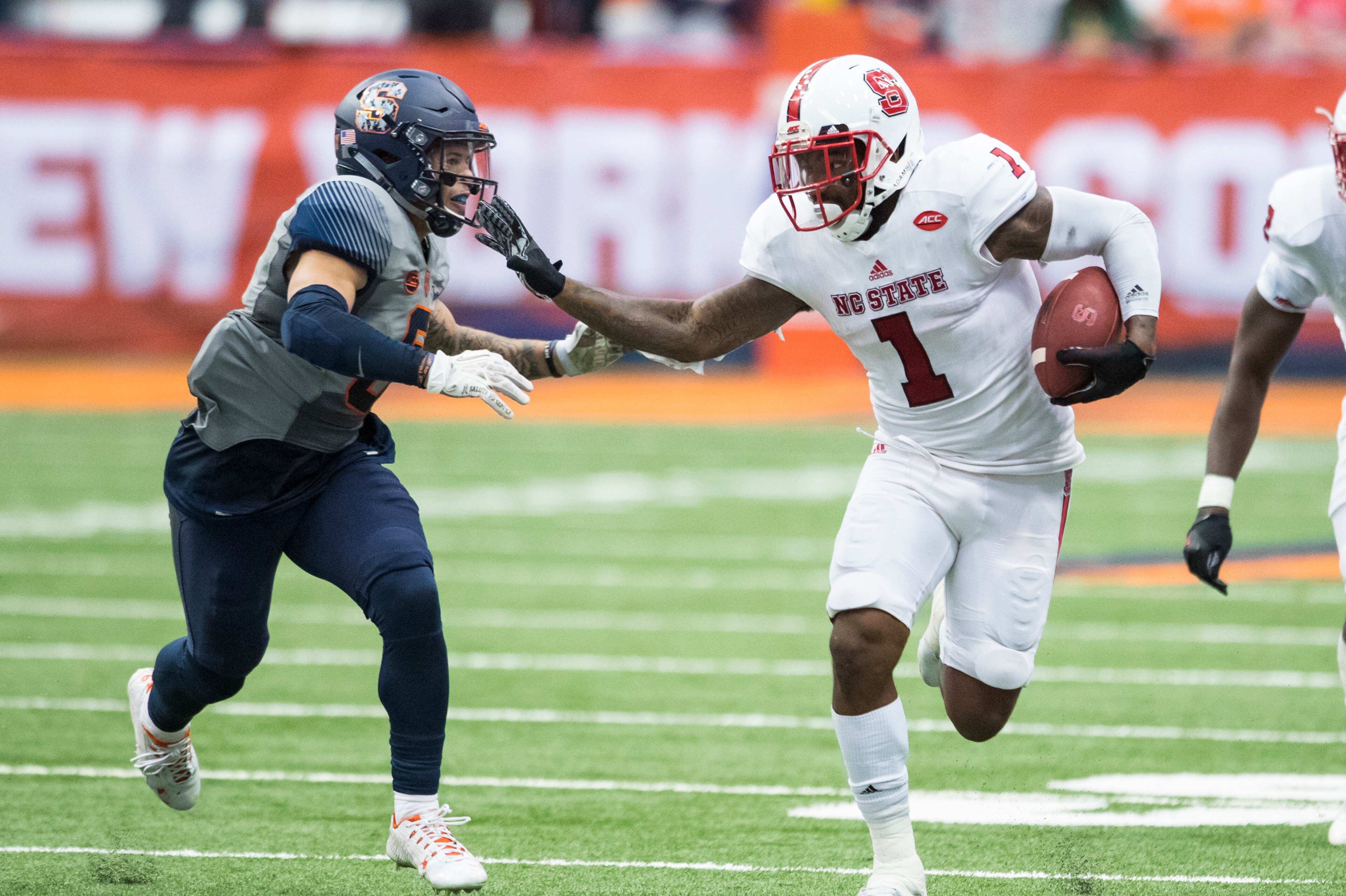 SYRACUSE, NY - NOVEMBER 12: Jaylen Samuels #1 of the North Carolina State Wolfpack fends off Rodney Williams #6 of the Syracuse Orange while carrying the ball on November 12, 2016 at The Carrier Dome in Syracuse, New York. (Photo by Brett Carlsen/Getty SYRACUSE, NY - NOVEMBER 12: Jaylen Samuels #1 of the North Carolina State Wolfpack fends off Rodney Williams #6 of the Syracuse Orange while carrying the ball on November 12, 2016 at The Carrier Dome in Syracuse, New York. (Photo by Brett Carlsen/Getty