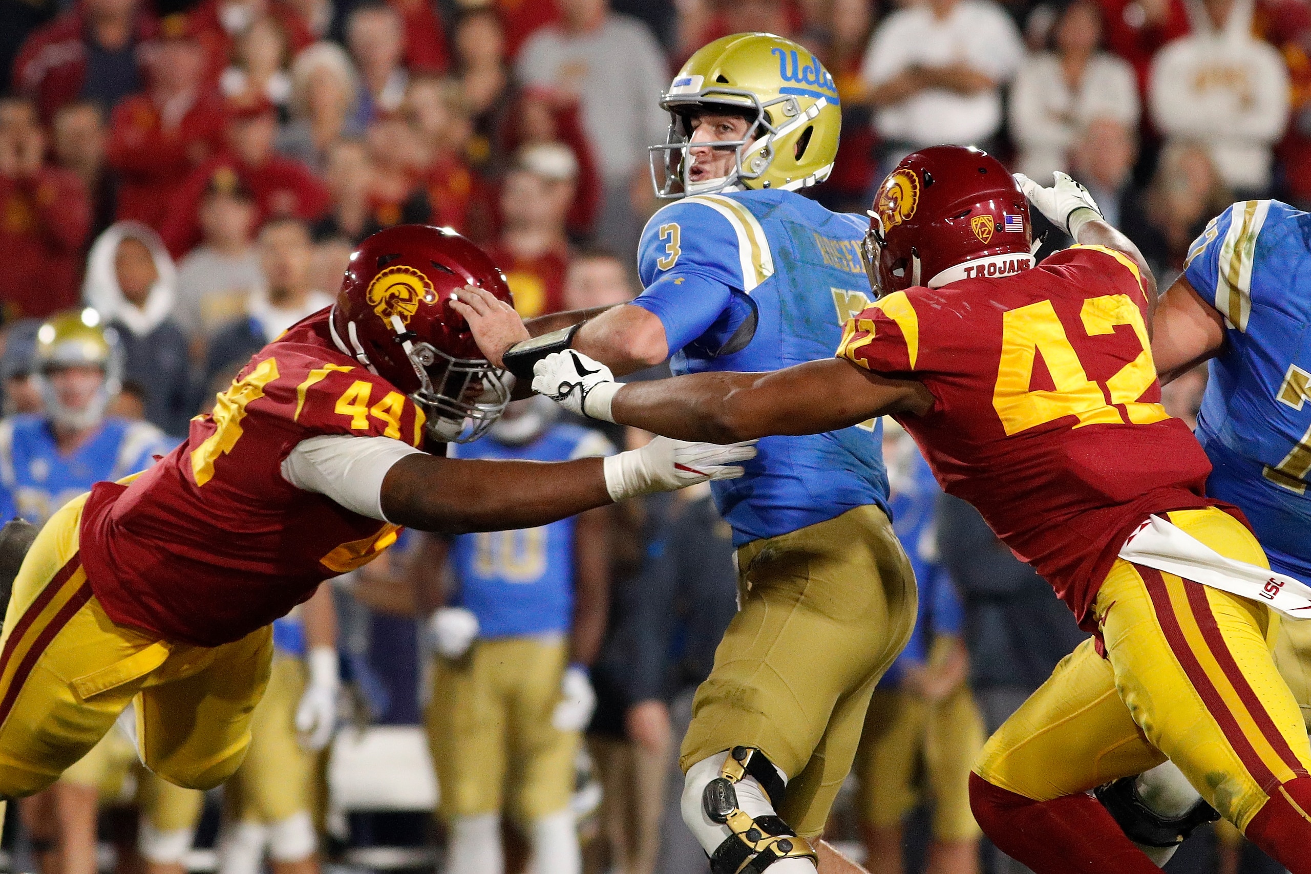 LOS ANGELES, CA - NOVEMBER 18:  Uchenna Nwosu #42 of the USC Trojans and Malik Dorton #44 of the USC Trojans sack Josh Rosen #3 of the UCLA Bruins at the end of the second quarter during the NCAA college football game at the Los Angeles Memorial Coliseum 