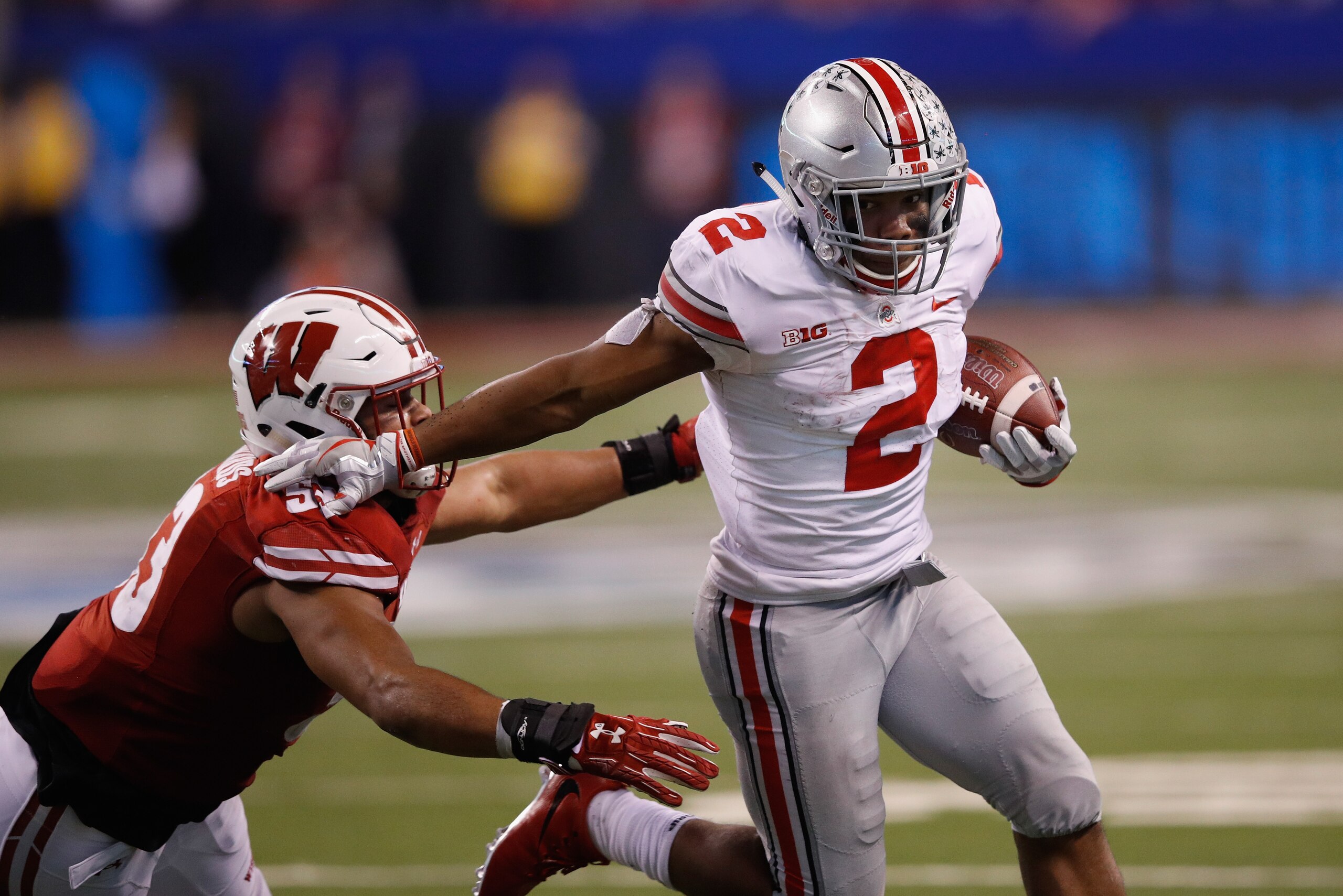 INDIANAPOLIS, IN - DECEMBER 02: Running back J.K. Dobbins #2 of the Ohio State Buckeyes runs the ball against linebacker T.J. Edwards #53 of the Wisconsin Badgers in the fourth quarter during the Big Ten Championship game at Lucas Oil Stadium on December 