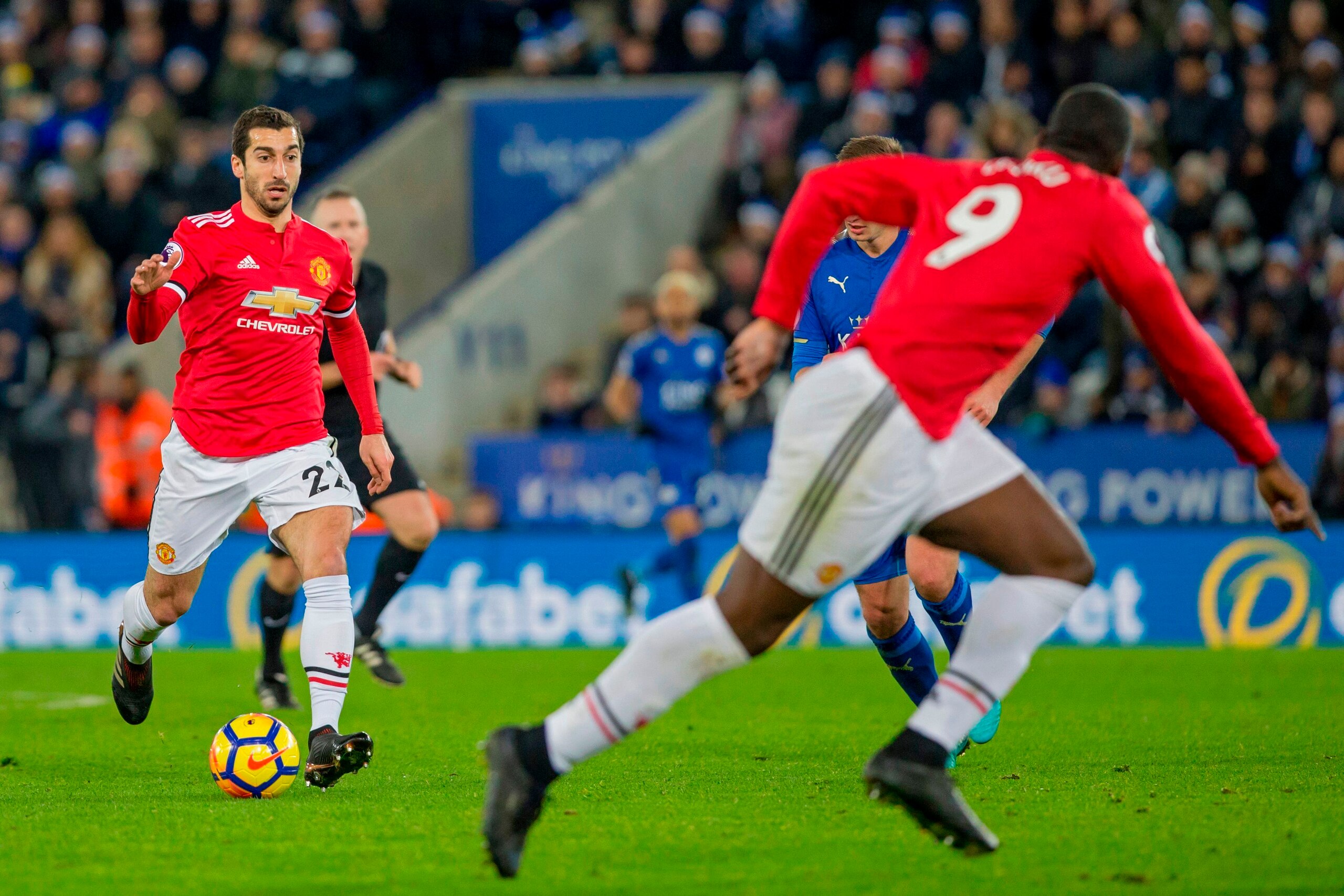 Manchester United's Armenian midfielder Henrikh Mkhitaryan (L) prepares to pass the ball during the English Premier League football match between Leicester City and Manchester United at King Power Stadium in Leicester, central England on December 23, 2017