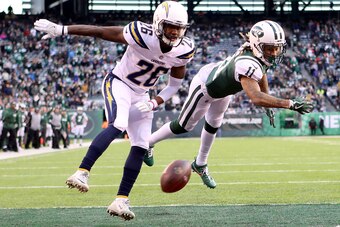 EAST RUTHERFORD, NJ - DECEMBER 24: Robby Anderson #11 of the New York Jets reaches for a catch against Casey Hayward #26 of the Los Angeles Chargers in the fourth quarter during their game at MetLife Stadium on December 24, 2017 in East Rutherford, New Je