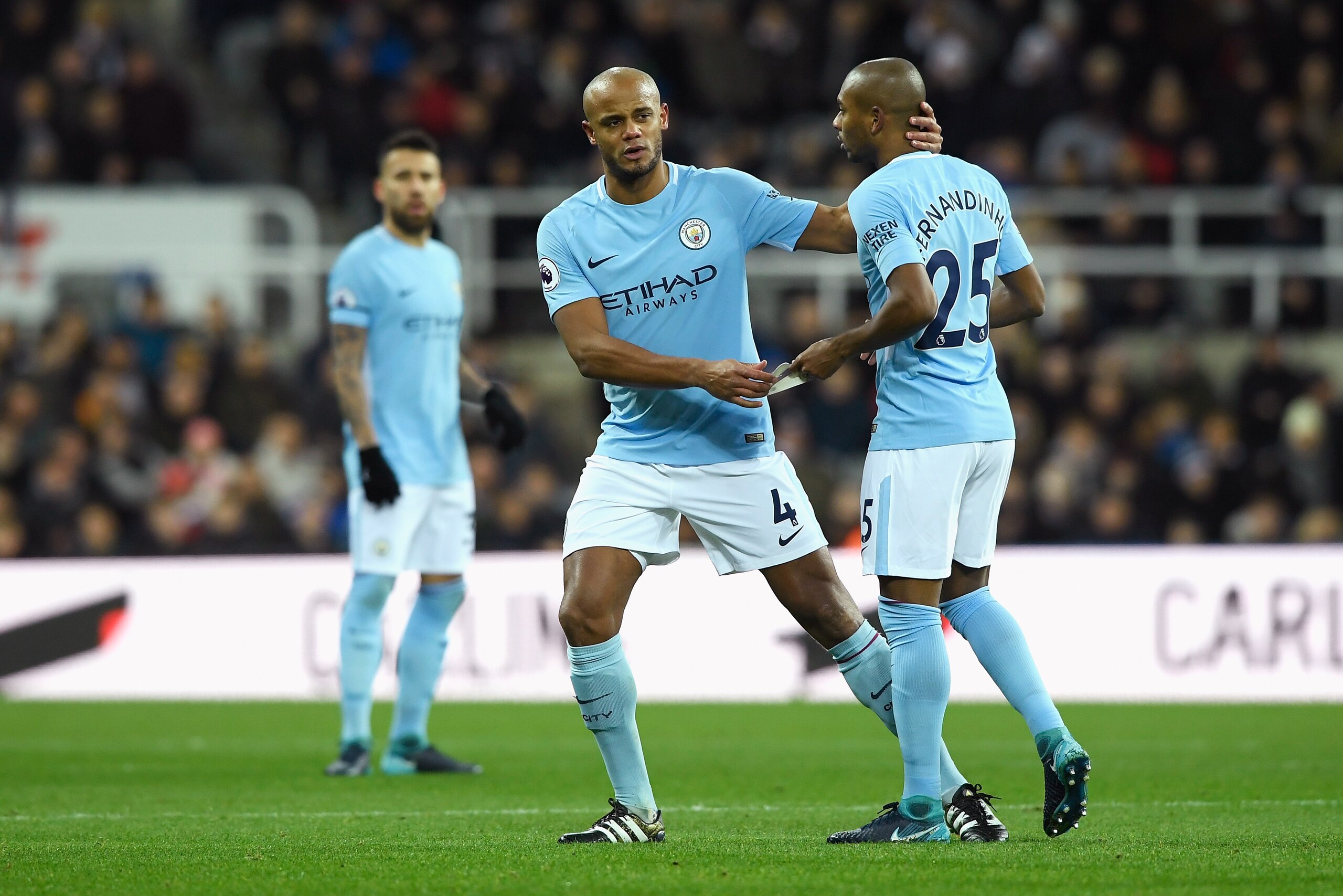 NEWCASTLE UPON TYNE, ENGLAND - DECEMBER 27:  Vincent Kompany of Manchester City gives his captain's armband to Fernandinho of Manchester City as he goes off injured during the Premier League match between Newcastle United and Manchester City at St. James'