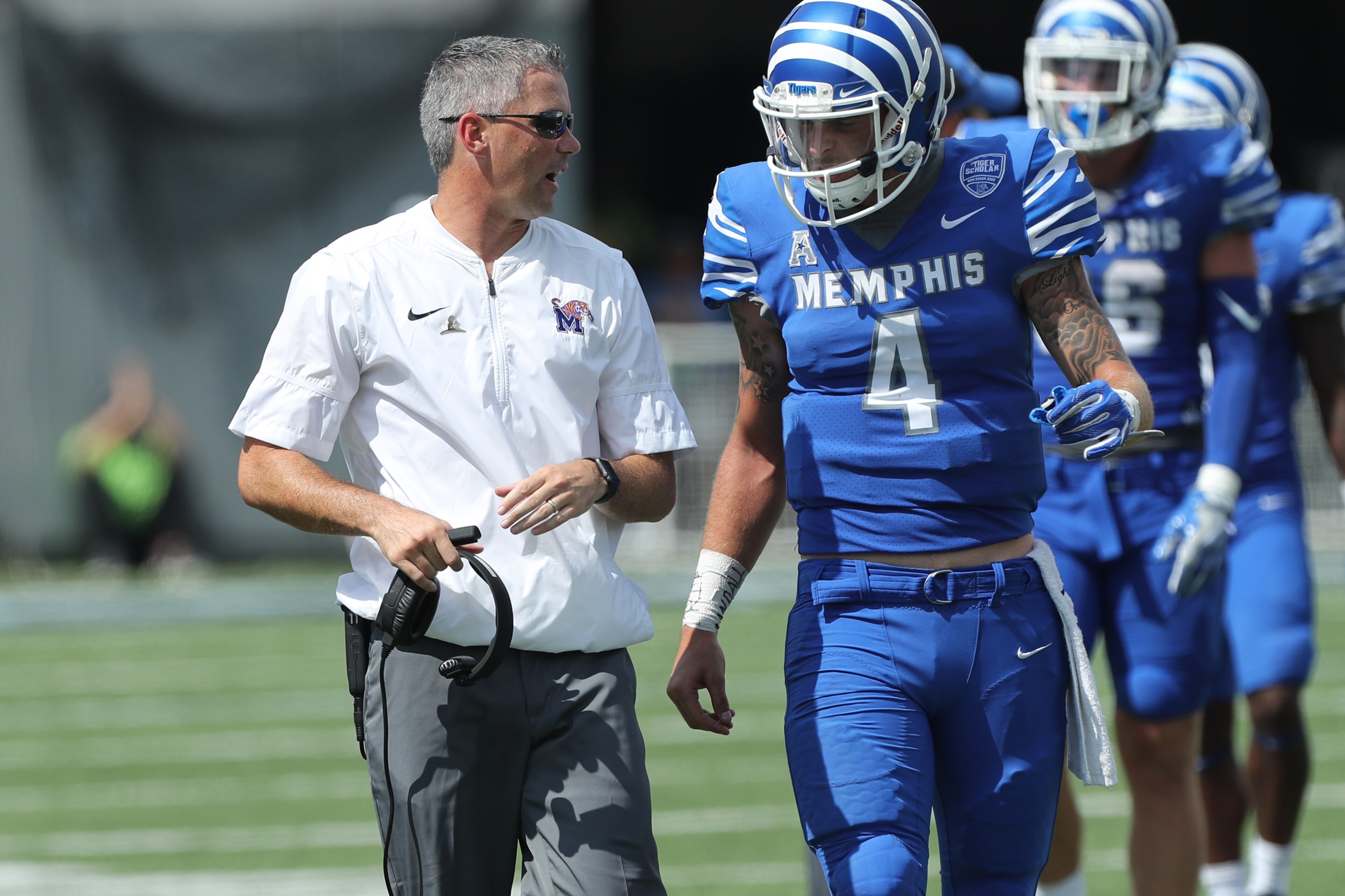 MEMPHIS, TN - SEPTEMBER 16: Mike Norvell, head coach of the Memphis Tigers talks with Riley Ferguson #4 of the Memphis Tigers during a game against the UCLA Bruins on September 16, 2017 at Liberty Bowl Memorial Stadium in Memphis, Tennessee. Memphis defea