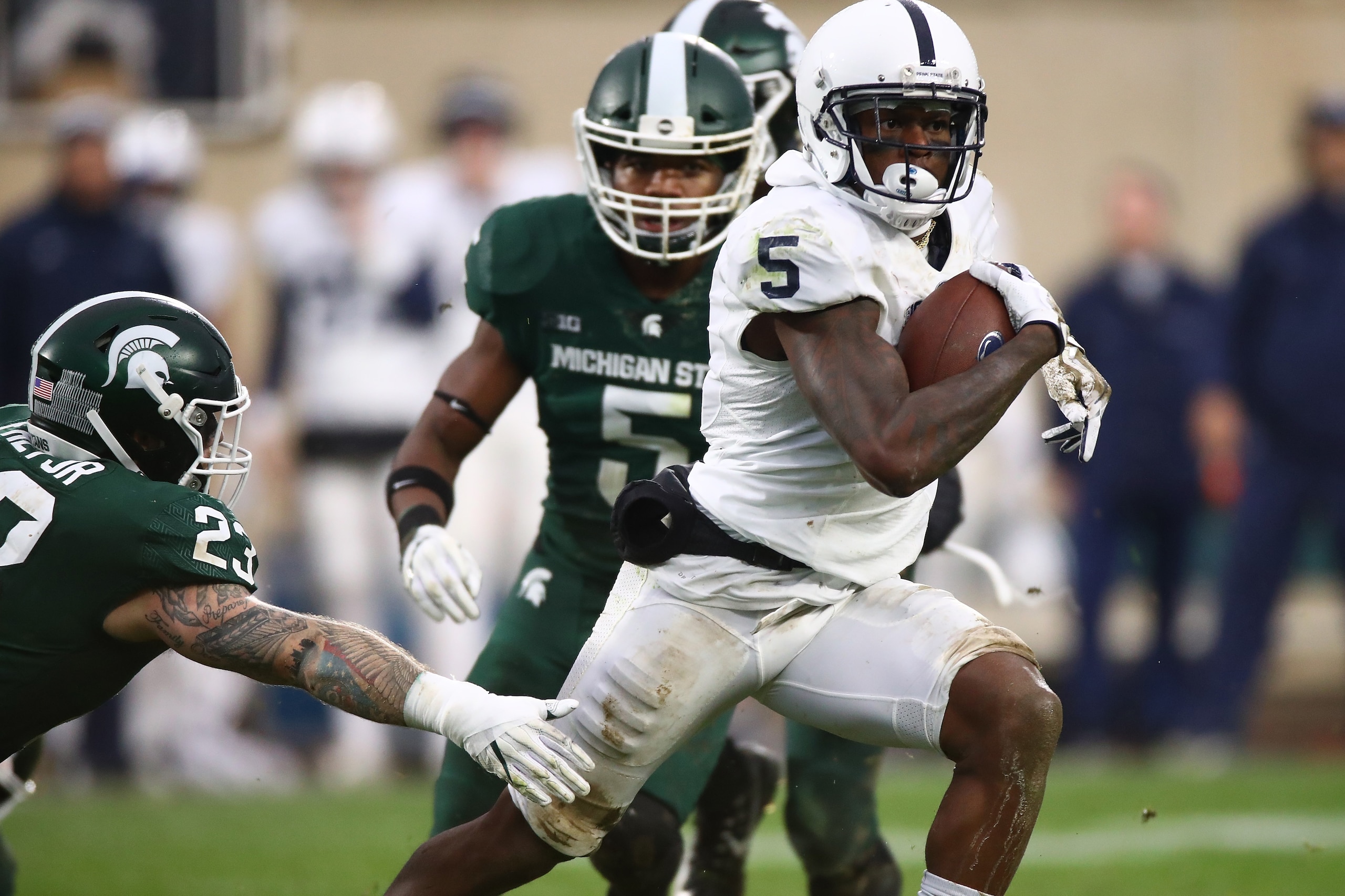 EAST LANSING, MI - NOVEMBER 04: DaeSean Hamilton #5 of the Penn State Nittany Lions races past the tackle of Chris Frey #23 of the Michigan State Spartans during the second half at Spartan Stadium on November 4, 2017 in East Lansing, Michigan. Michigan St