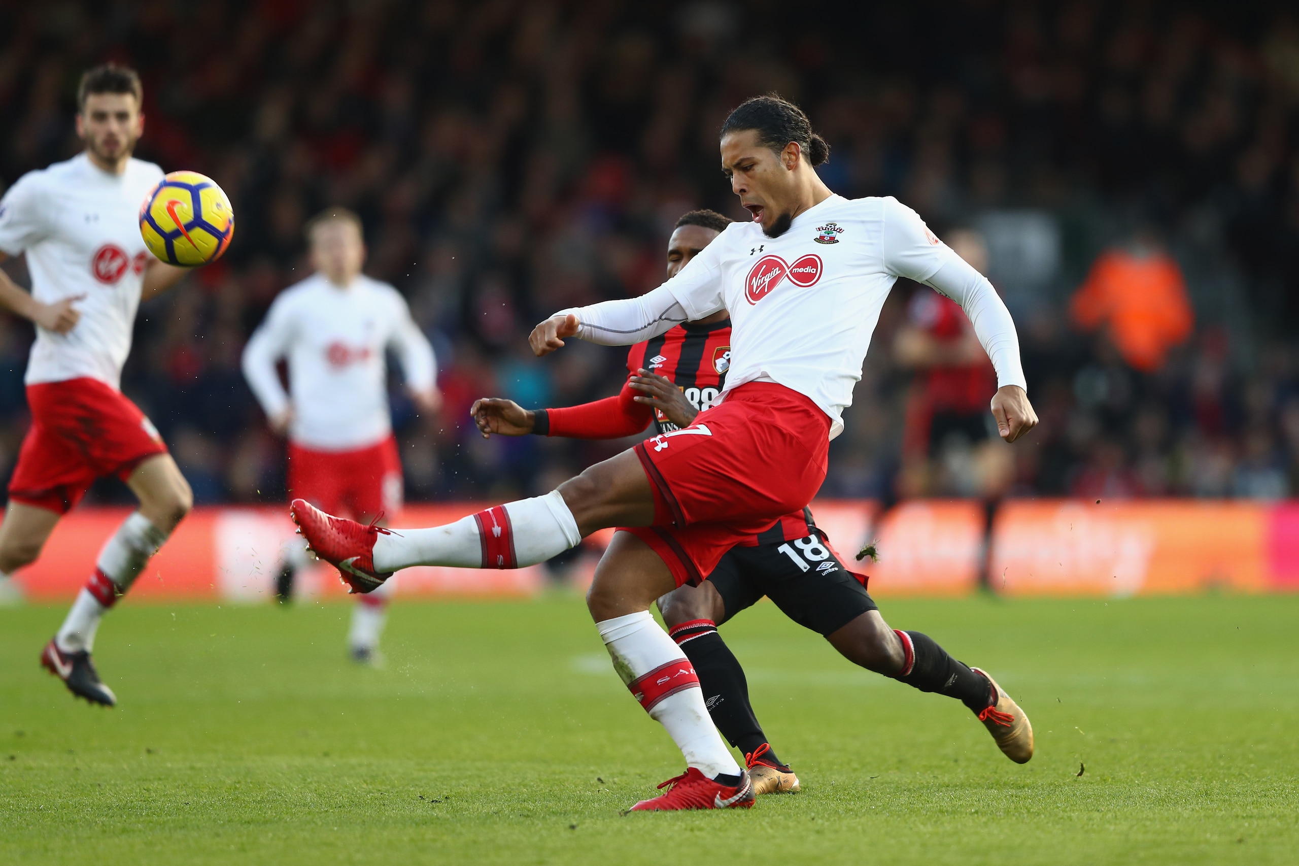 BOURNEMOUTH, ENGLAND - DECEMBER 03: Virgil van Dijk of Southampton clears the ball while under pressure from Jermain Defoe of AFC Bournemouth during the Premier League match between AFC Bournemouth and Southampton at Vitality Stadium on December 3, 2017 i