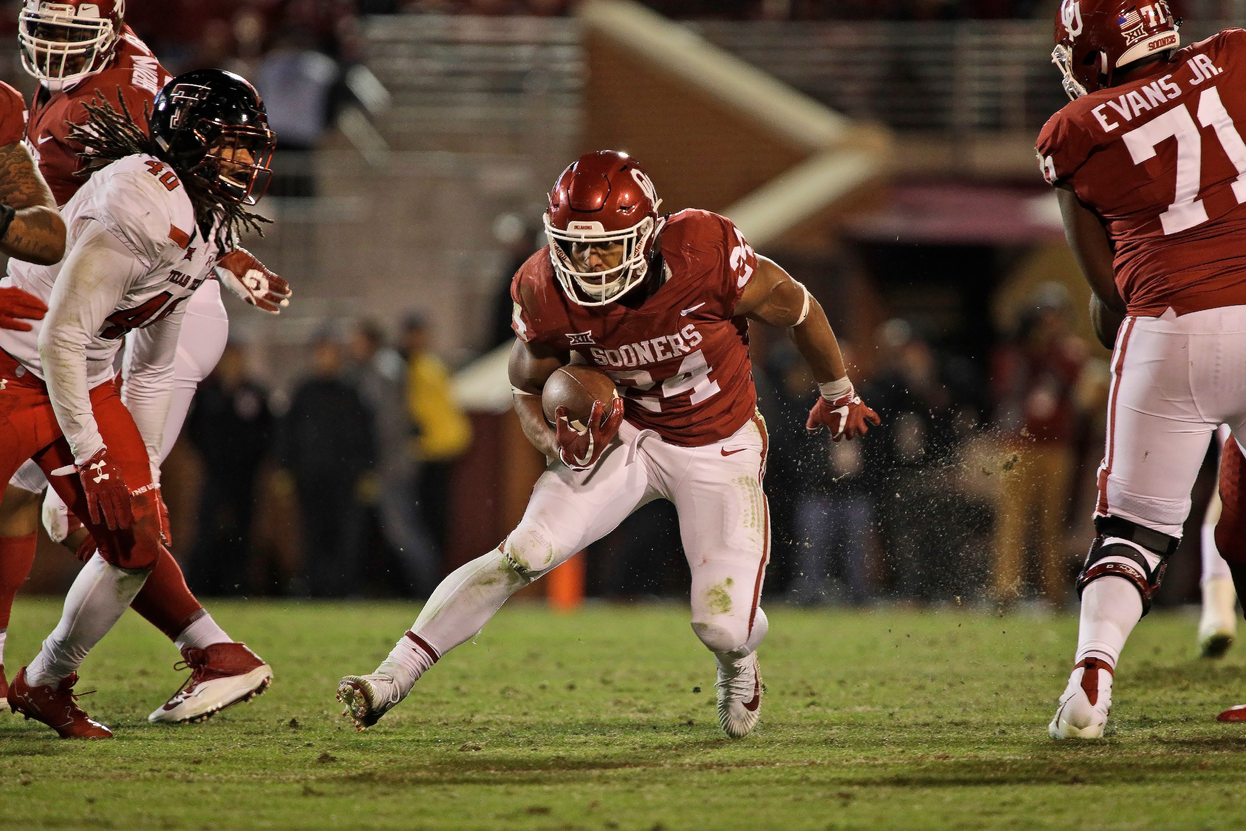 NORMAN, OK - OCTOBER 28: Running back Rodney Anderson #24 of the Oklahoma Sooners looks for an opening against the Texas Tech Red Raiders at Gaylord Family Oklahoma Memorial Stadium on October 28, 2017 in Norman, Oklahoma. Oklahoma defeated Texas Tech 49-