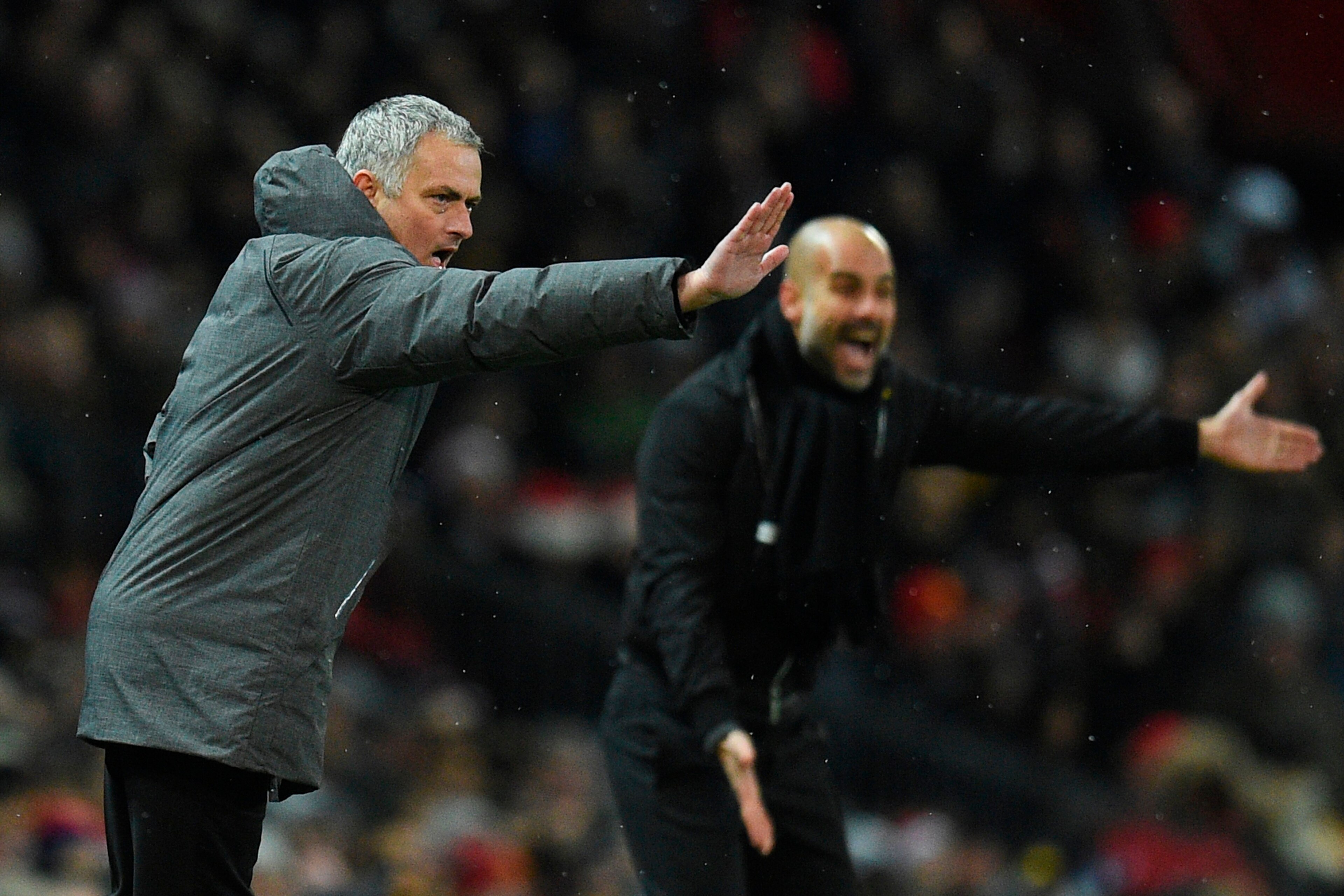 Manchester United's Portuguese manager Jose Mourinho (L) and Manchester City's Spanish manager Pep Guardiola (R) gestures from the touchline during the English Premier League football match between Manchester United and Manchester City at Old Trafford in 