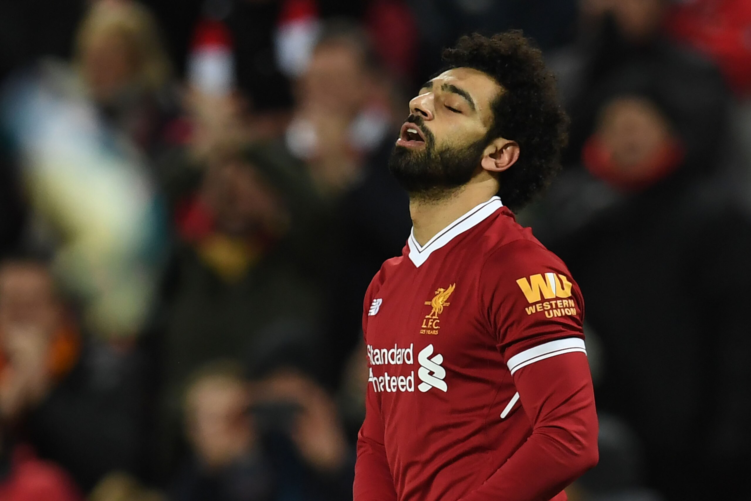 Liverpool's Egyptian midfielder Mohamed Salah celebrates scoring the second goal during the English Premier League football match between Liverpool and Leicester at Anfield in Liverpool, north west England on December 30, 2017. / AFP PHOTO / Paul ELLIS / 