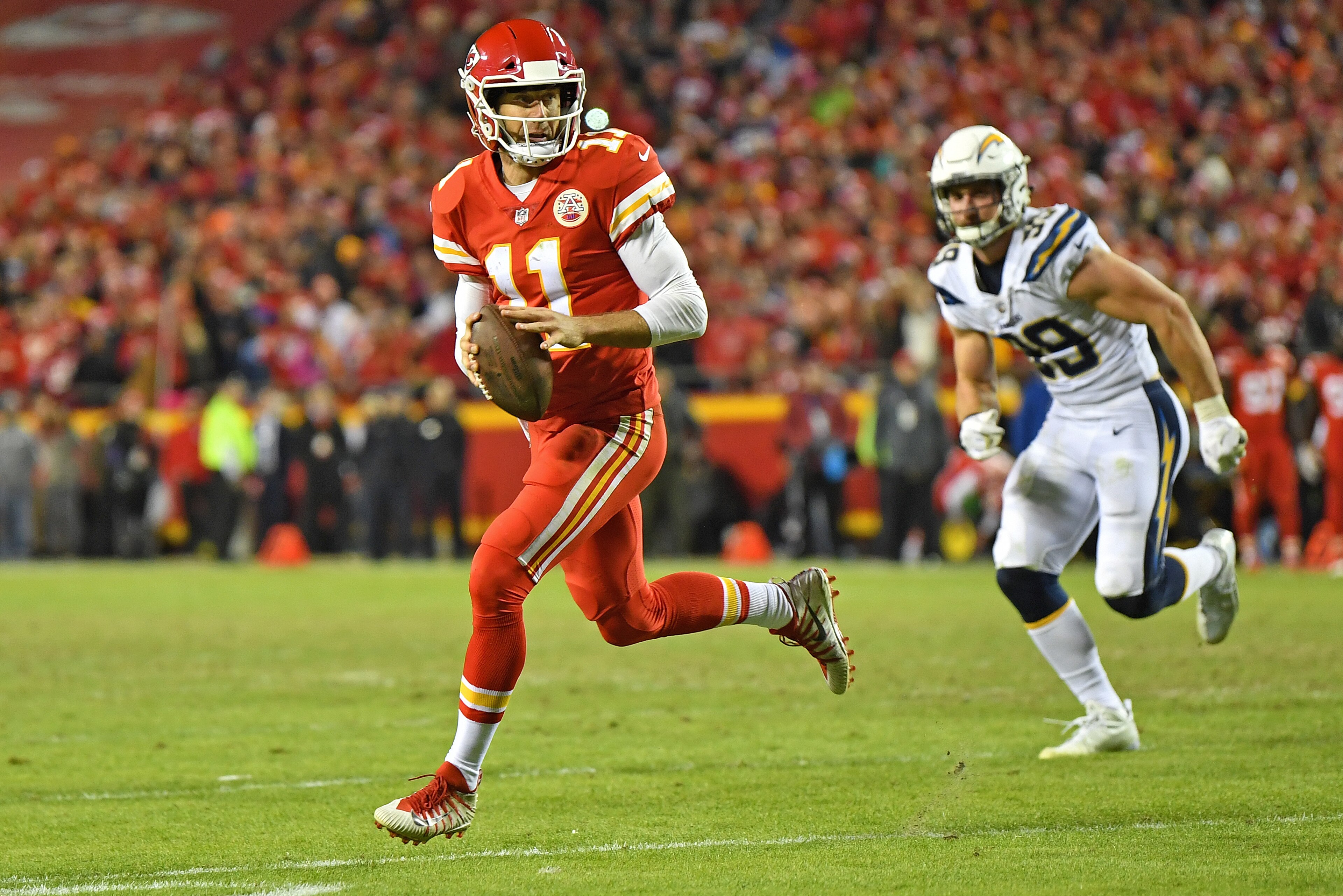 KANSAS CITY, MO - DECEMBER 16:  Quarterback Alex Smith #11 of the Kansas City Chiefs rolls out on a pass play against the Los Angeles Chargers during the second half at Arrowhead Stadium on December 16, 2017 in Kansas City, Missouri.  (Photo by Peter G. A
