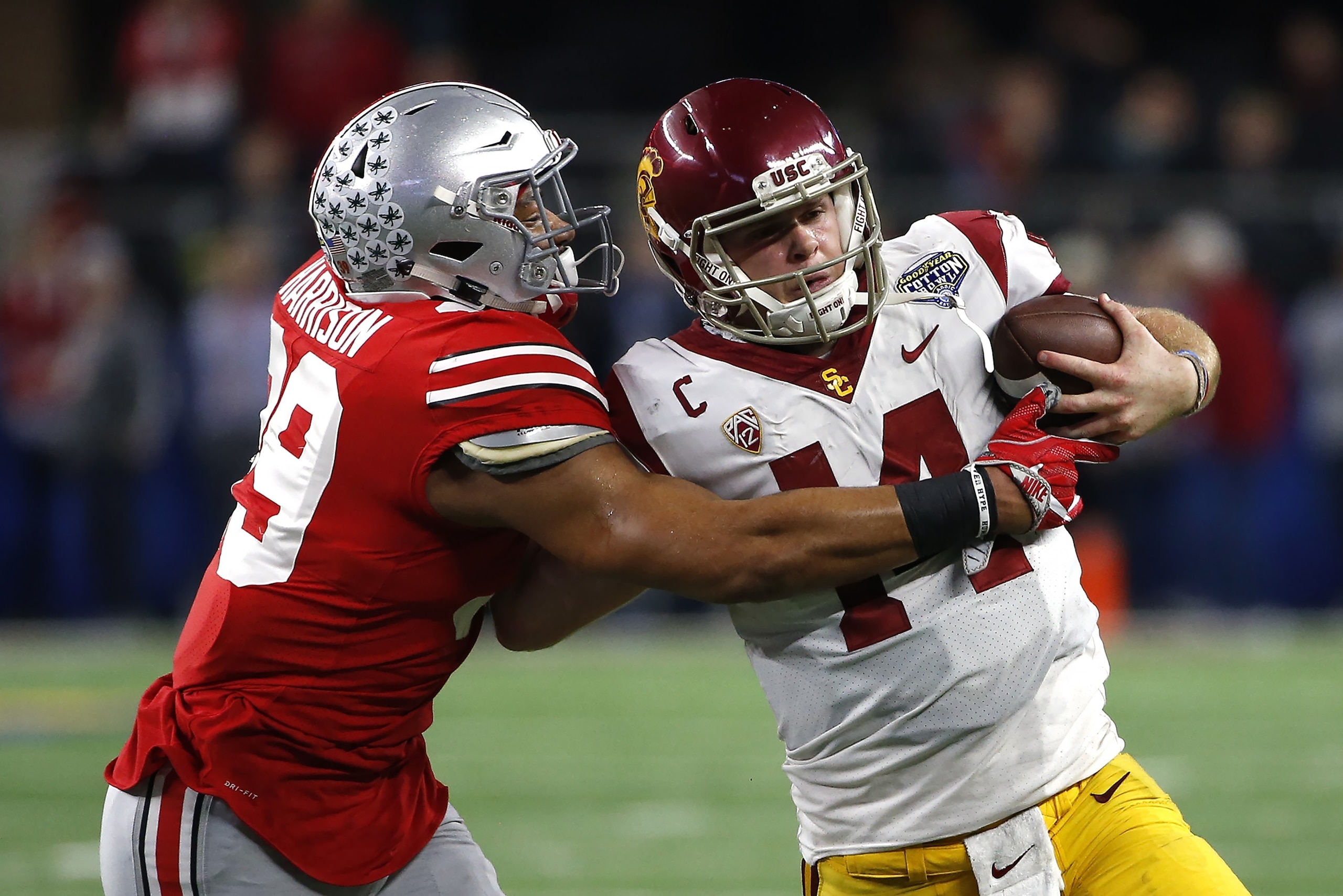 ARLINGTON, TX - DECEMBER 29: Malik Harrison #39 of the Ohio State Buckeyes runs Sam Darnold #14 of the USC Trojans out of bounds in the second half of the 82nd Goodyear Cotton Bowl Classic between USC and Ohio State at AT&T Stadium on December 29, 2017 in