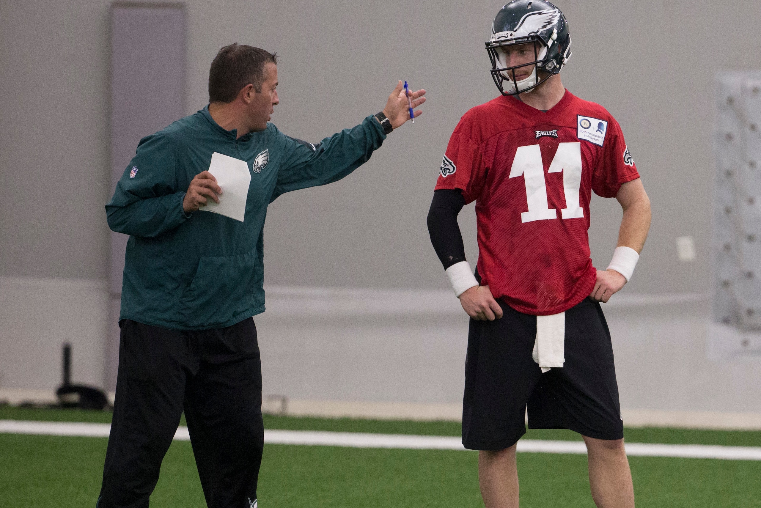 PHILADELPHIA, PA - MAY 13: Quarterbacks coach John DeFilippo of the Philadelphia Eagles talks to Carson Wentz #11 during rookie camp at the NovaCare Complex on May 13, 2016 in Philadelphia, Pennsylvania. (Photo by Mitchell Leff/Getty Images)