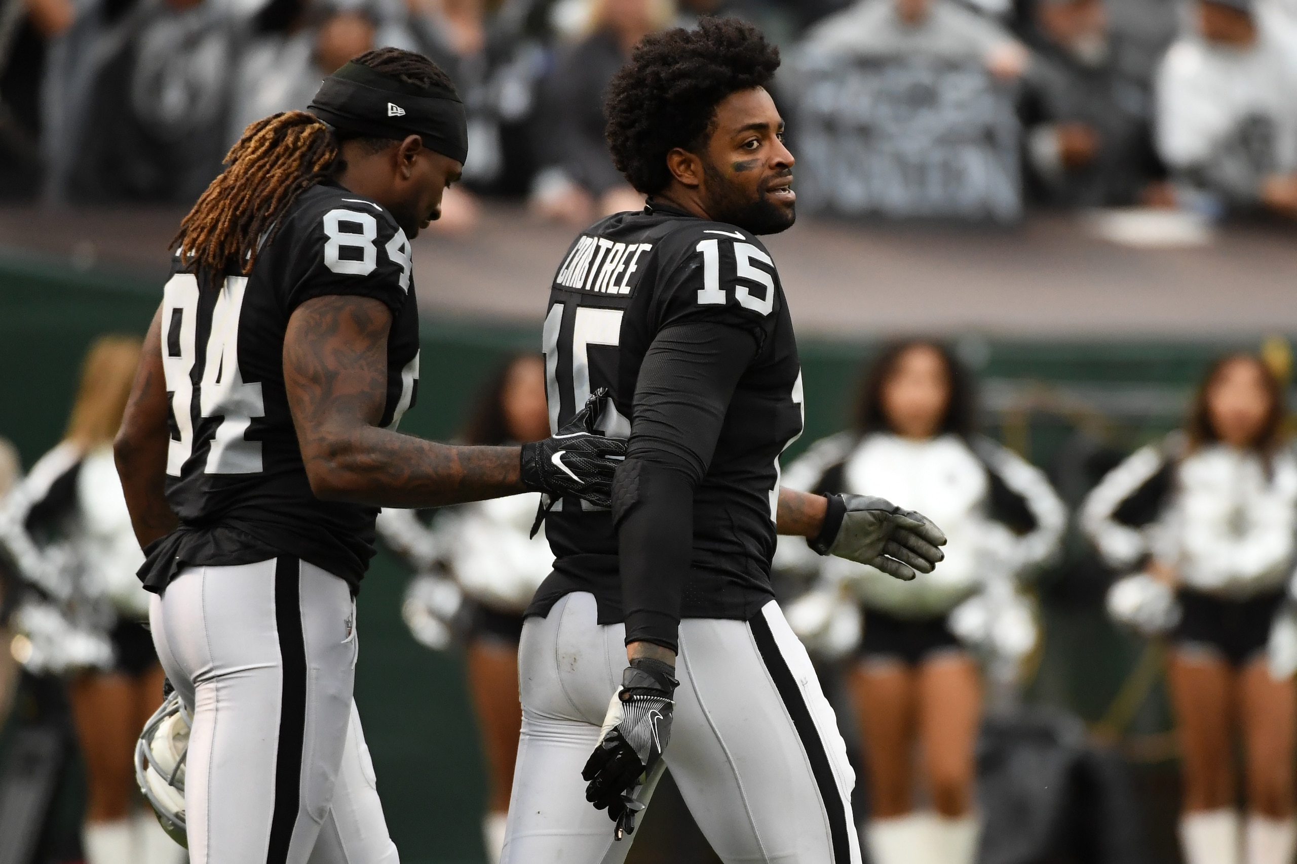 OAKLAND, CA - NOVEMBER 26:  Michael Crabtree #15 of the Oakland Raiders is walked off the field by Cordarrelle Patterson #84 after being ejected for fighting with Aqib Talib #21 of the Denver Broncos during their NFL game at Oakland-Alameda County Coliseu