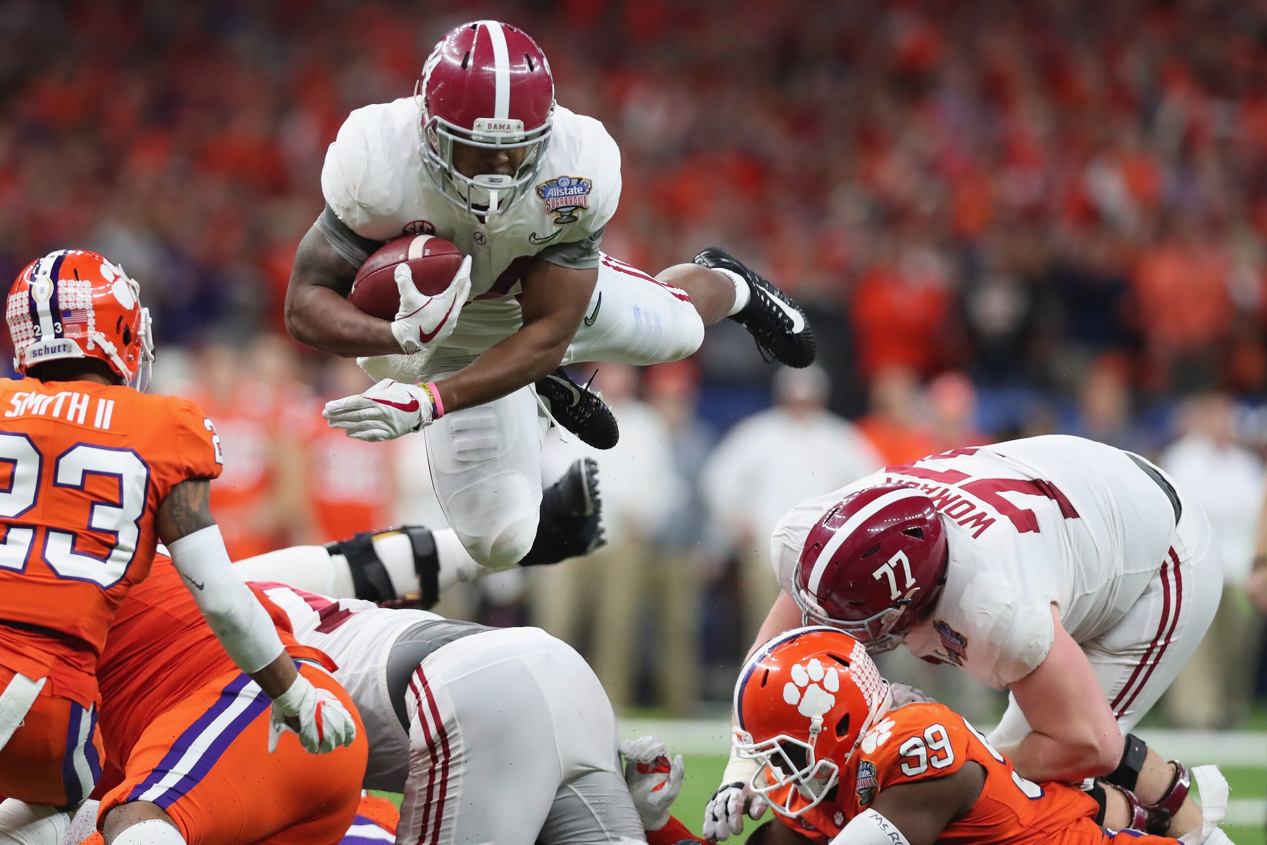 NEW ORLEANS, LA - JANUARY 01:  Damien Harris #34 of the Alabama Crimson Tide dives with the ball as Van Smith #23 of the Clemson Tigers defends in the second half of the AllState Sugar Bowl at the Mercedes-Benz Superdome on January 1, 2018 in New Orleans,