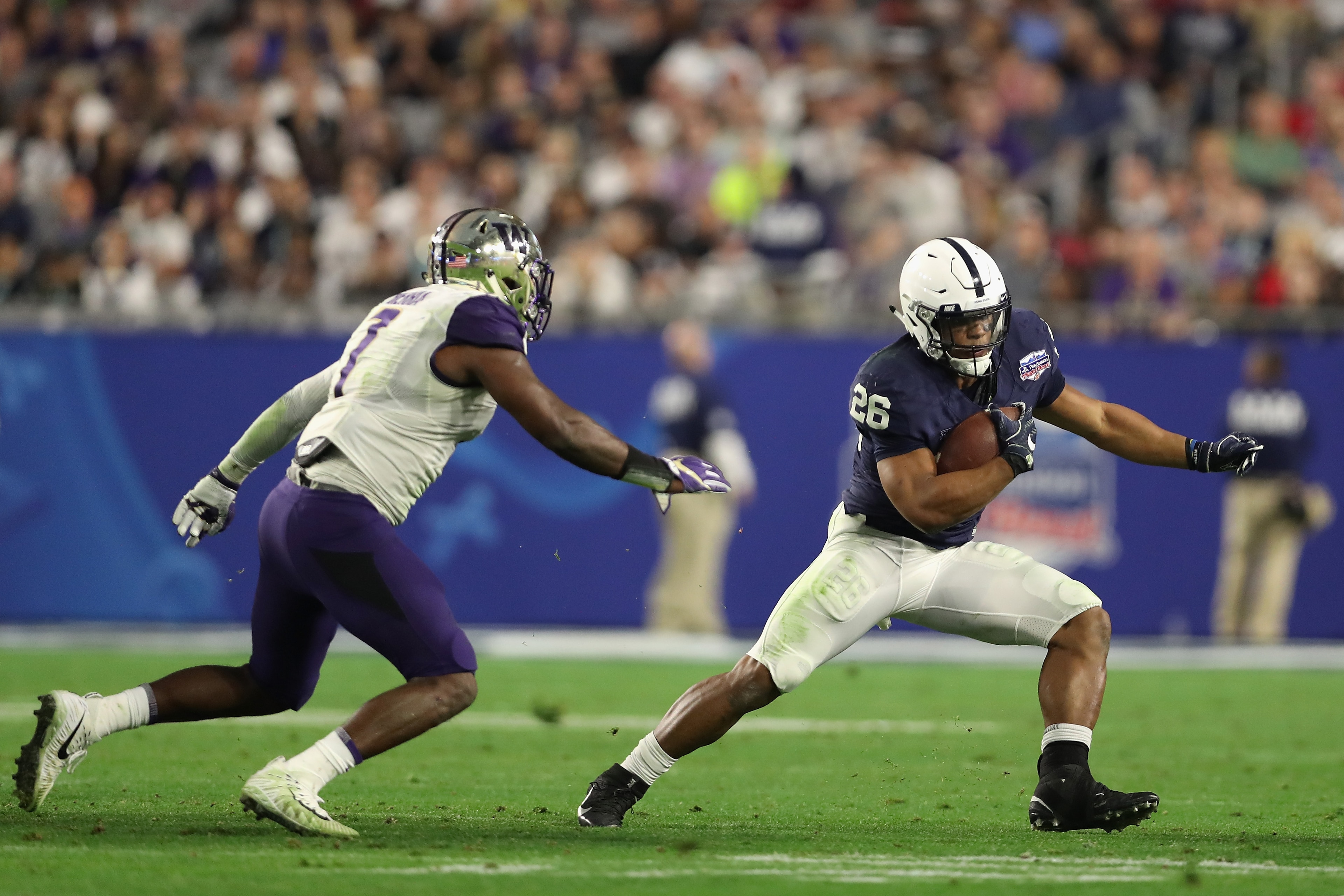 GLENDALE, AZ - DECEMBER 30:  Running back Saquon Barkley #26 of the Penn State Nittany Lions rushes the football against linebacker Keishawn Bierria #7 of the Washington Huskies during the second half of the Playstation Fiesta Bowl at University of Phoeni