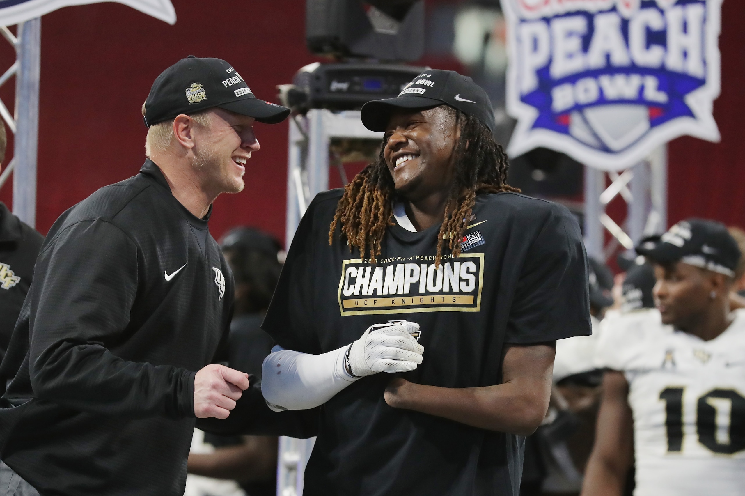 ATLANTA, GA - JANUARY 01:  Head coach Scott Frost of the UCF Knights celebrates with Shaquem Griffin #18 after defeating the Auburn Tigers 34-27 to win the Chick-fil-A Peach Bowl at Mercedes-Benz Stadium on January 1, 2018 in Atlanta, Georgia.  (Photo by 