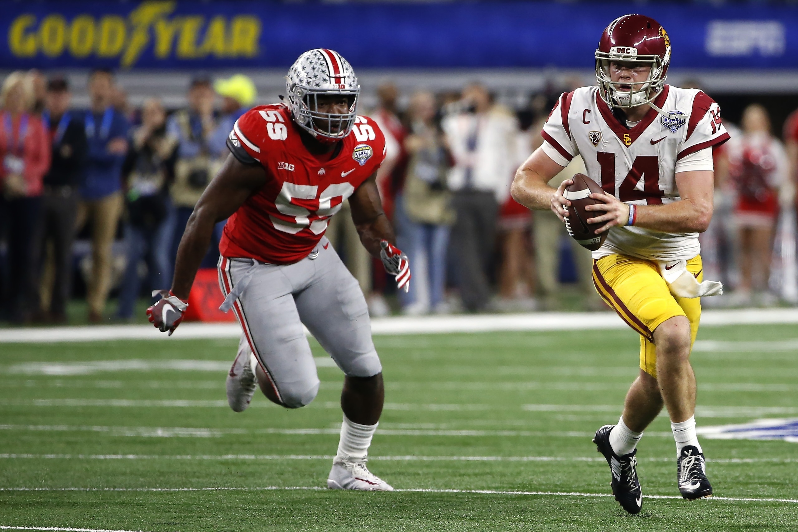 ARLINGTON, TX - DECEMBER 29: Sam Darnold #14 of the USC Trojans runs from Tyquan Lewis #59 of the Ohio State Buckeyes in the second half of the 82nd Goodyear Cotton Bowl Classic between USC and Ohio State at AT&T Stadium on December 29, 2017 in Arlington,