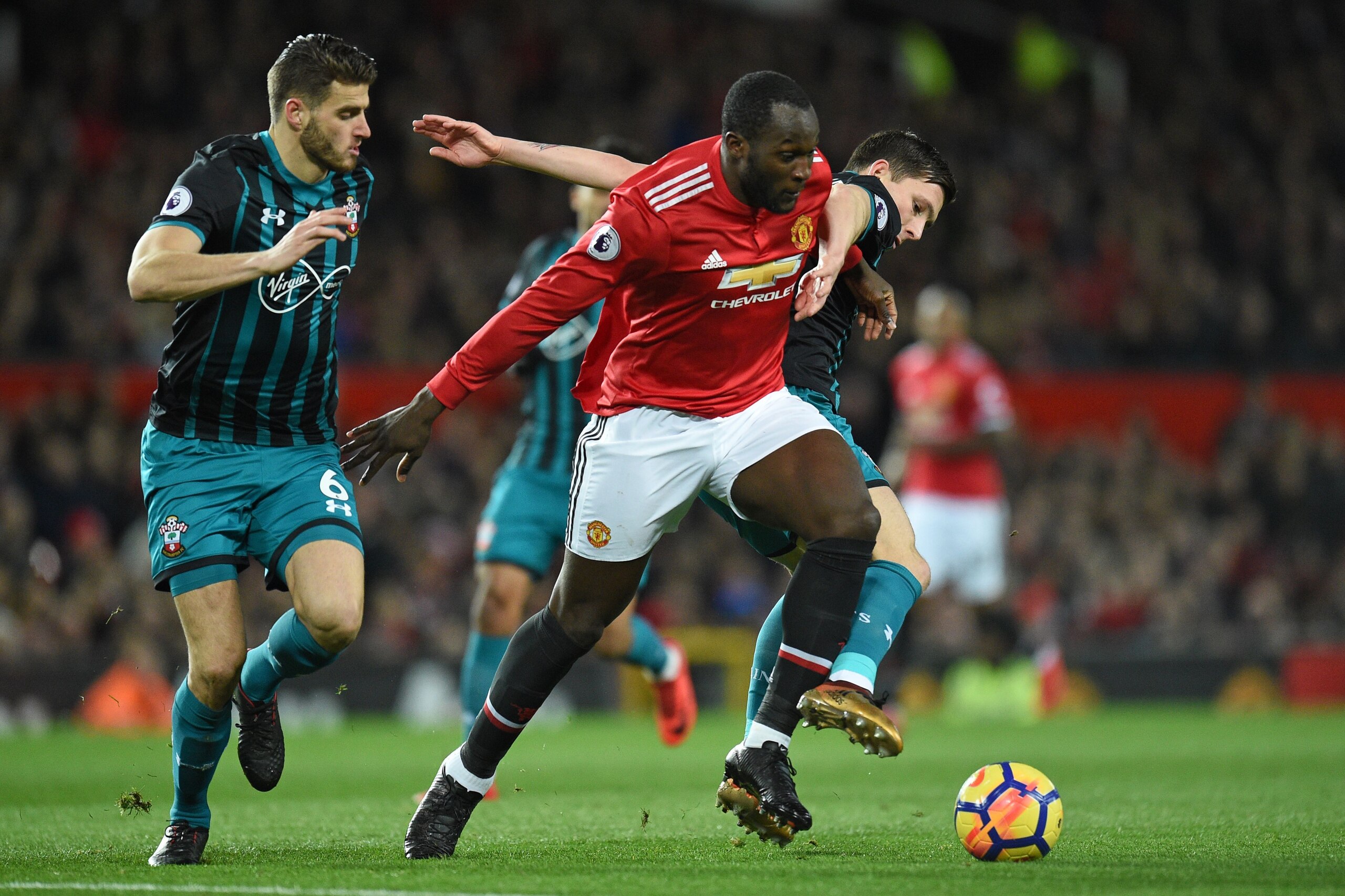 Manchester United's Belgian striker Romelu Lukaku (2nd R) vies with Southampton's Danish midfielder Pierre-Emile Hojbjerg (R) and Southampton's Dutch defender Wesley Hoedt (L) during the English Premier League football match between Manchester United and 