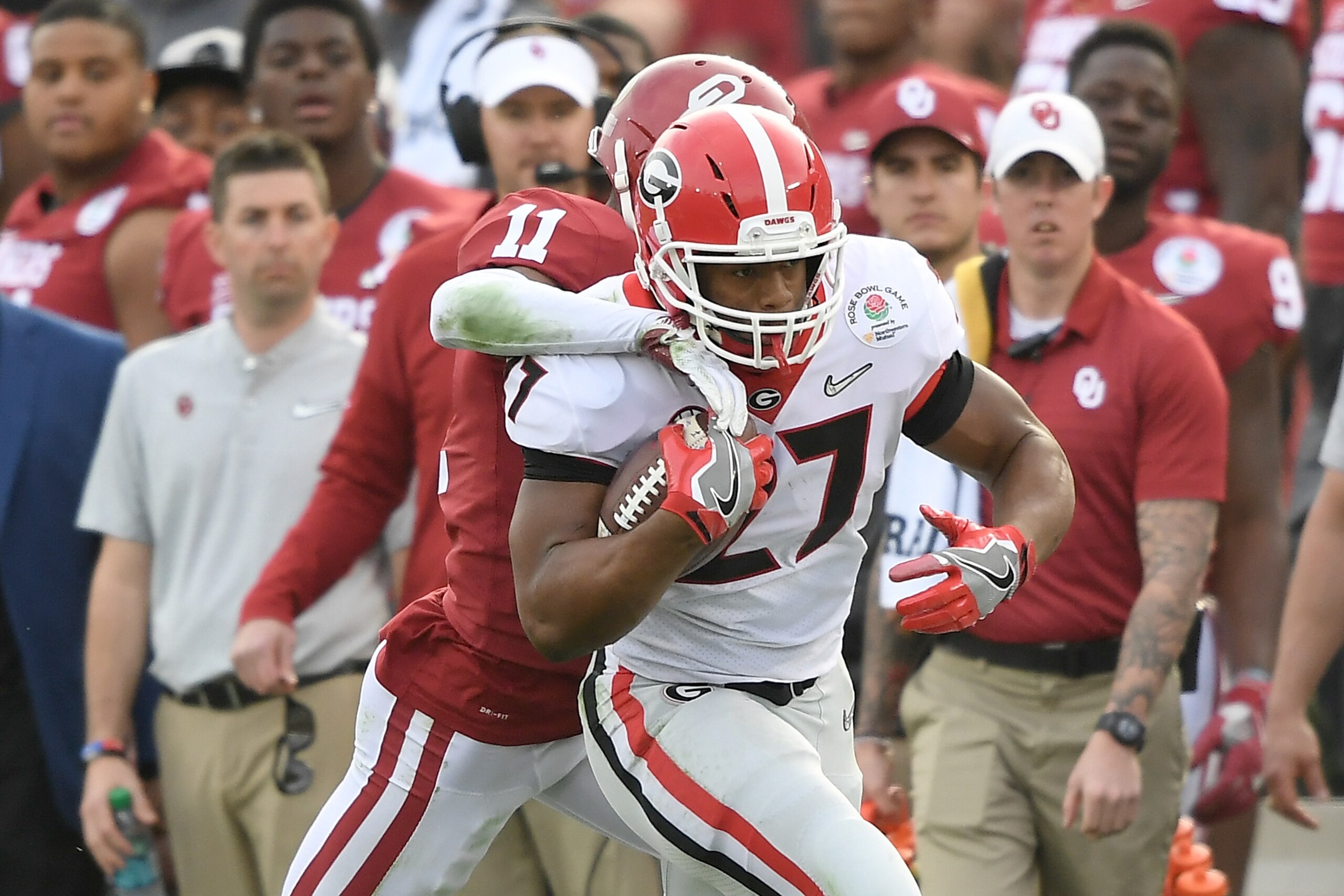 PASADENA, CA - JANUARY 01:  Running back Nick Chubb #27 of the Georgia Bulldogs runs the ball against cornerback Parnell Motley #11 of the Oklahoma Sooners in the first half in the 2018 College Football Playoff Semifinal at the Rose Bowl Game presented by