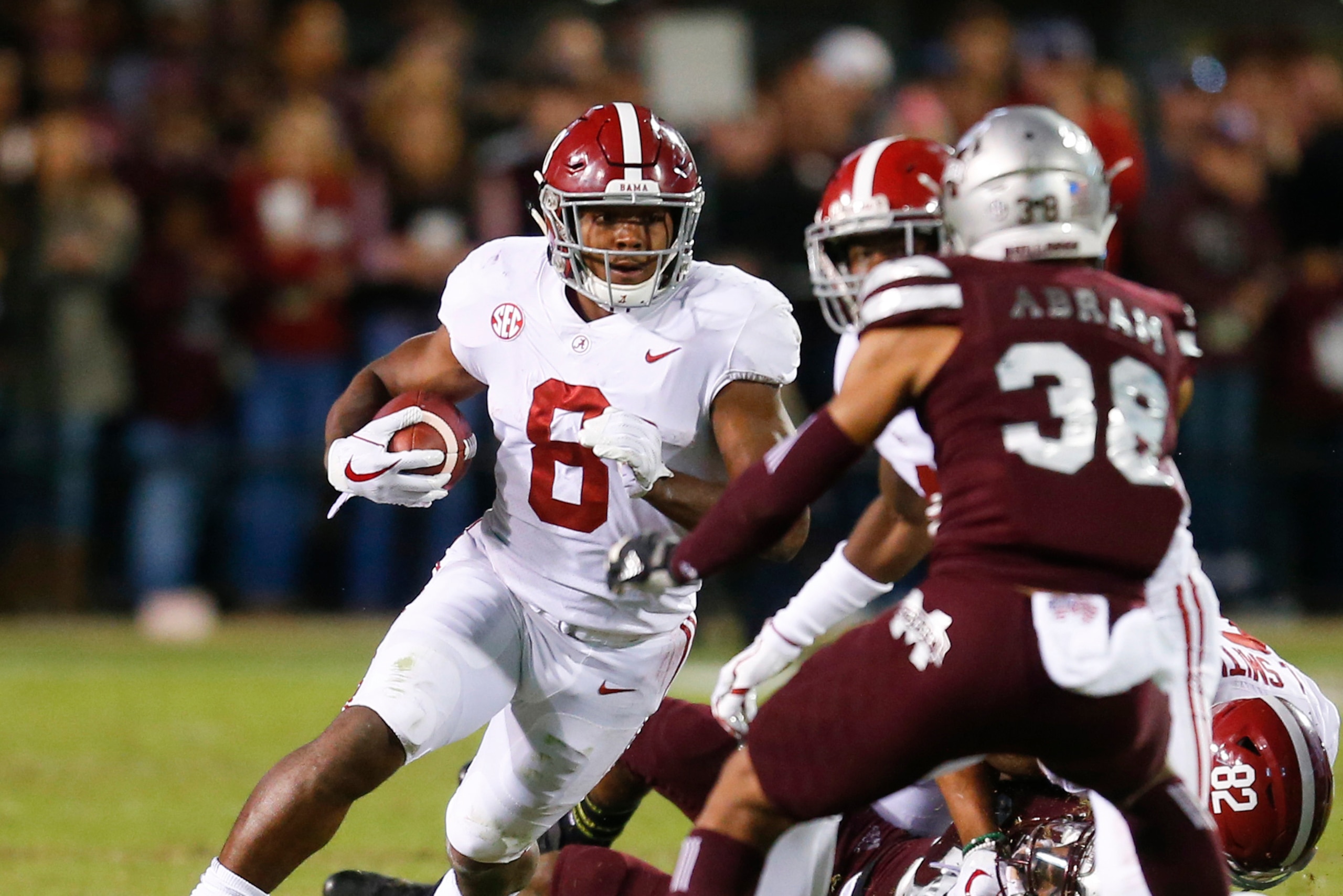 STARKVILLE, MS - NOVEMBER 11:  Josh Jacobs #8 of the Alabama Crimson Tide carries the ball for a first down during the second half of an NCAA football game against the Mississippi State Bulldogs at Davis Wade Stadium on November 11, 2017 in Starkville, Mi