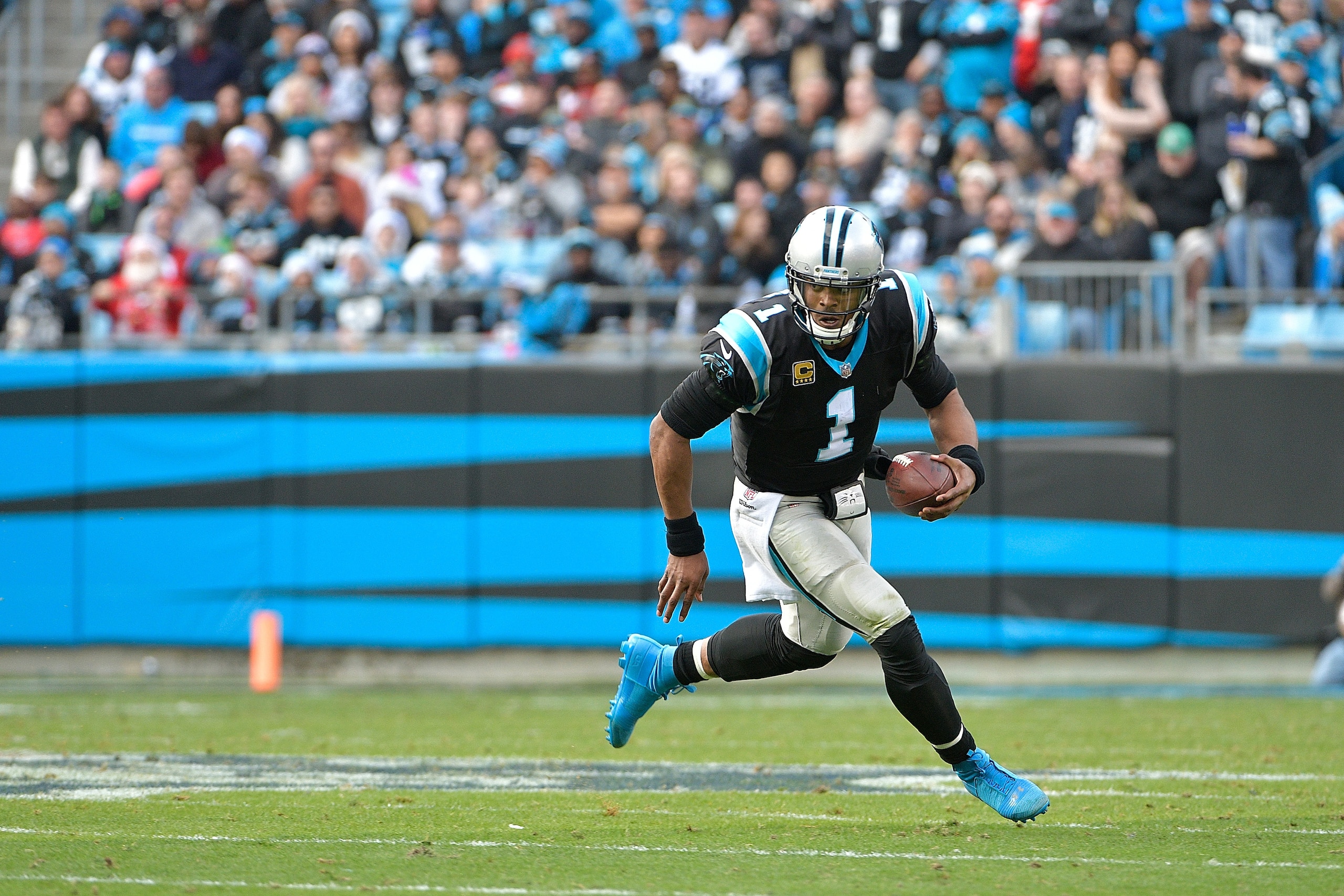 CHARLOTTE, NC - DECEMBER 24:  Cam Newton #1 of the Carolina Panthers runs against the Tampa Bay Buccaneers during their game at Bank of America Stadium on December 24, 2017 in Charlotte, North Carolina.  (Photo by Grant Halverson/Getty Images)
