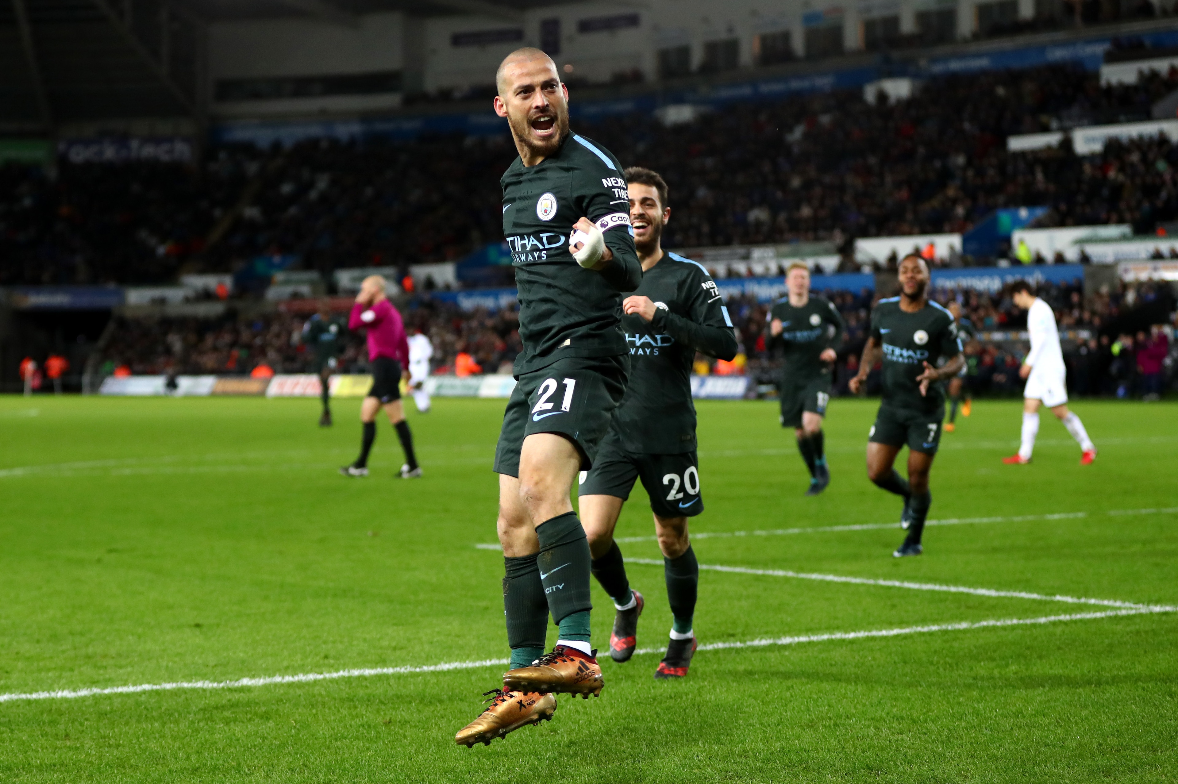 SWANSEA, WALES - DECEMBER 13:  David Silva of Manchester City celebrates after scoring his sides third goal during the Premier League match between Swansea City and Manchester City at Liberty Stadium on December 13, 2017 in Swansea, Wales.  (Photo by Mich