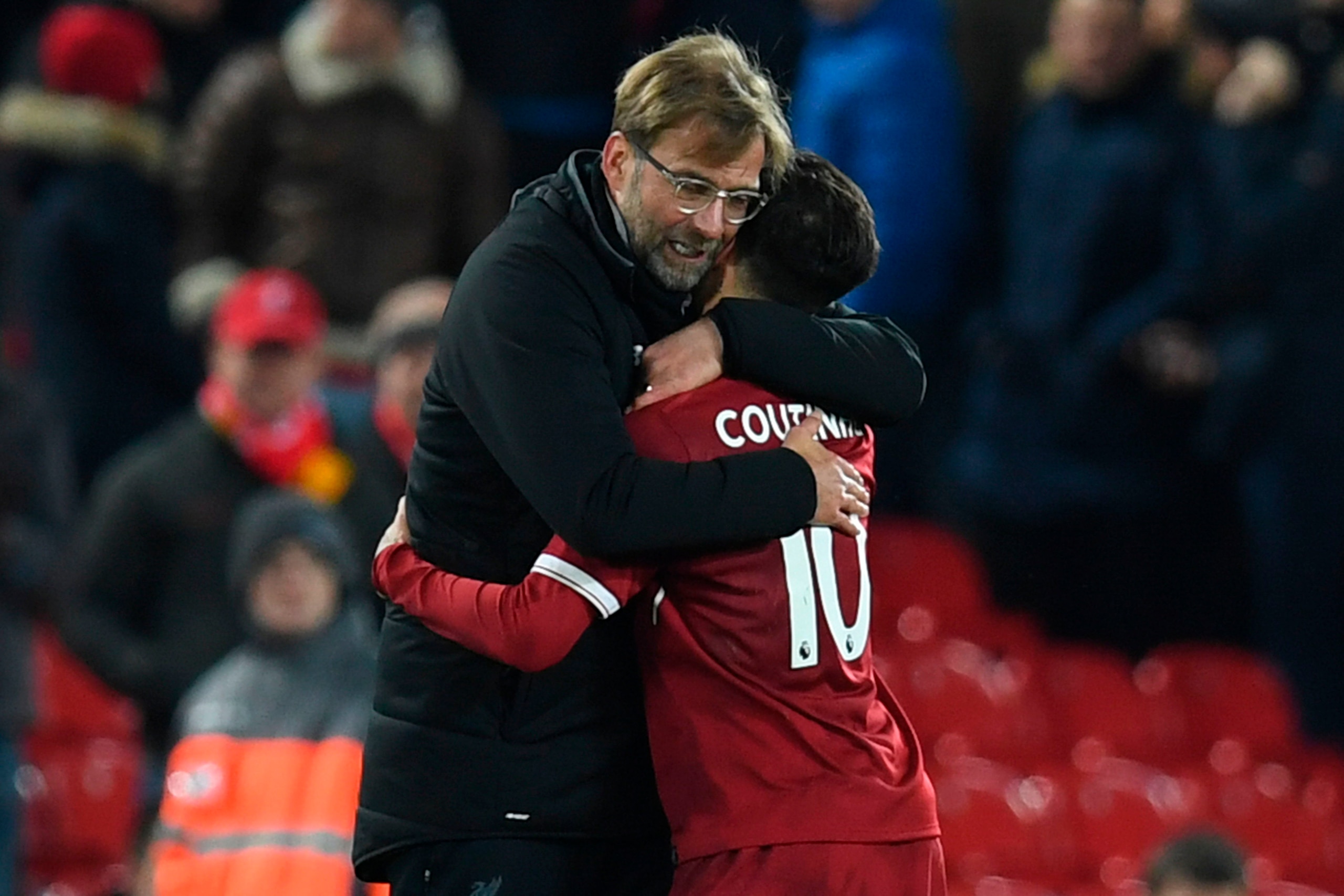Liverpool's German manager Jurgen Klopp (L) hugs Liverpool's Brazilian midfielder Philippe Coutinho (R) applauds after the final whistle during the English Premier League football match between Liverpool and Swansea City at Anfield in Liverpool, north wes Liverpool's German manager Jurgen Klopp (L) hugs Liverpool's Brazilian midfielder Philippe Coutinho (R) applauds after the final whistle during the English Premier League football match between Liverpool and Swansea City at Anfield in Liverpool, north wes