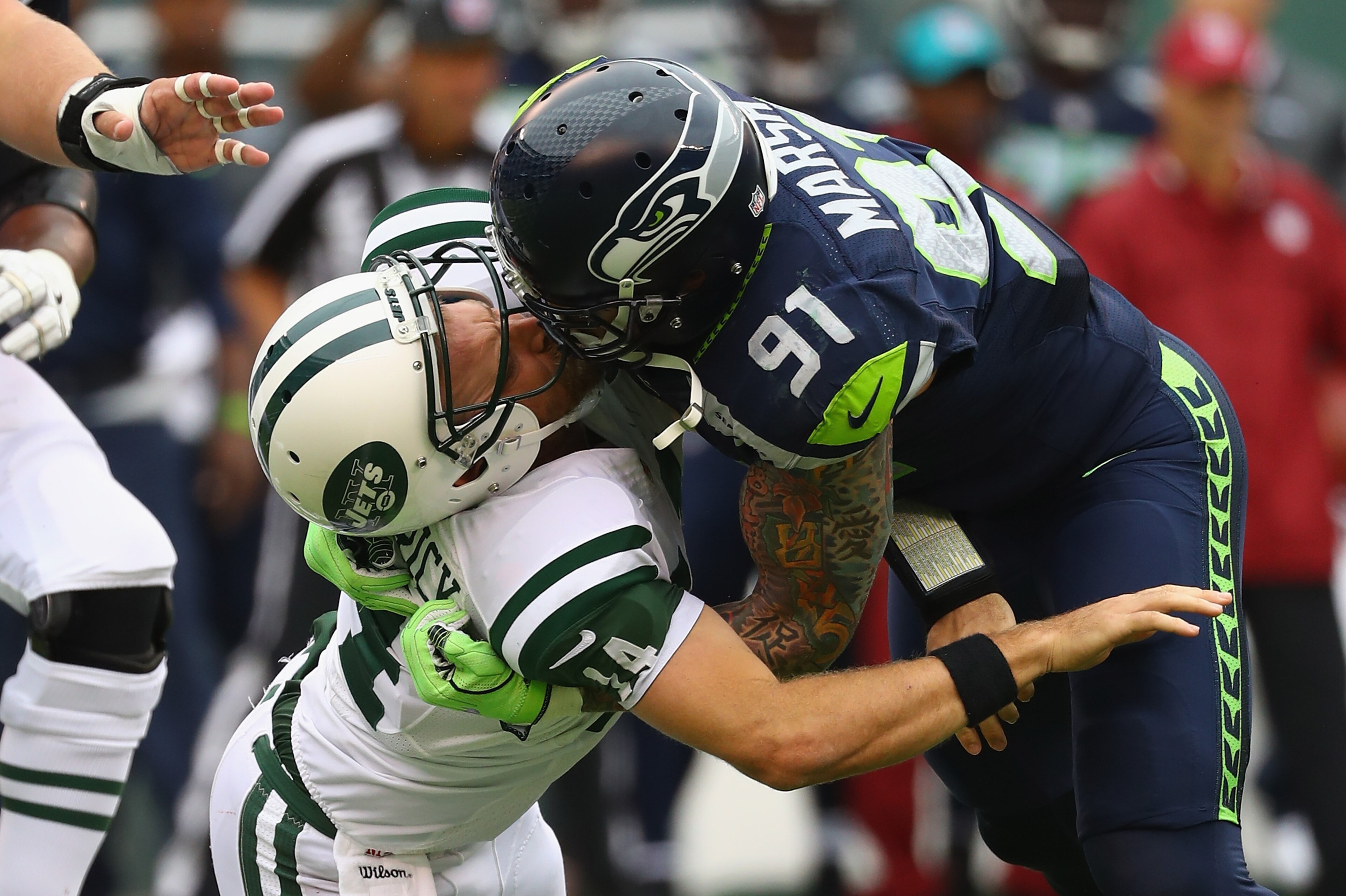 EAST RUTHERFORD, NJ - OCTOBER 02:  Cassius Marsh #91 of the Seattle Seahawks hits his helmet against quarterback Ryan Fitzpatrick #14 of the New York Jets for a penalty 'Roughing the Passer' in the second quarter at MetLife Stadium on October 2, 2016 in E
