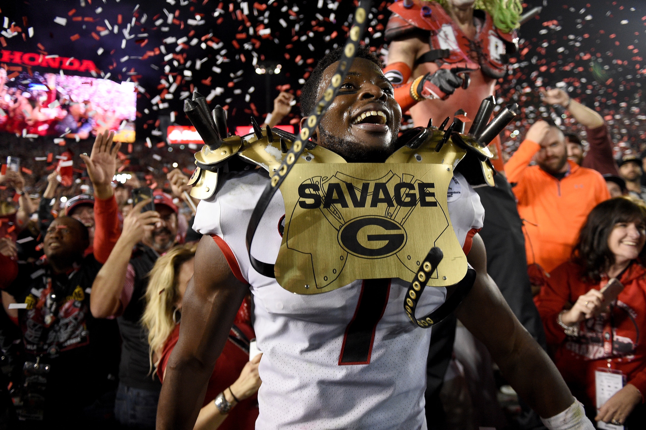 PASADENA, CA - JANUARY 01:  Linebacker Lorenzo Carter #7 of the Georgia Bulldogs  celebrates with a fan after winning the 2018 College Football Playoff Semifinal at the Rose Bowl Game presented by Northwestern Mutual against the Oklahoma Sooners 54-48 at 