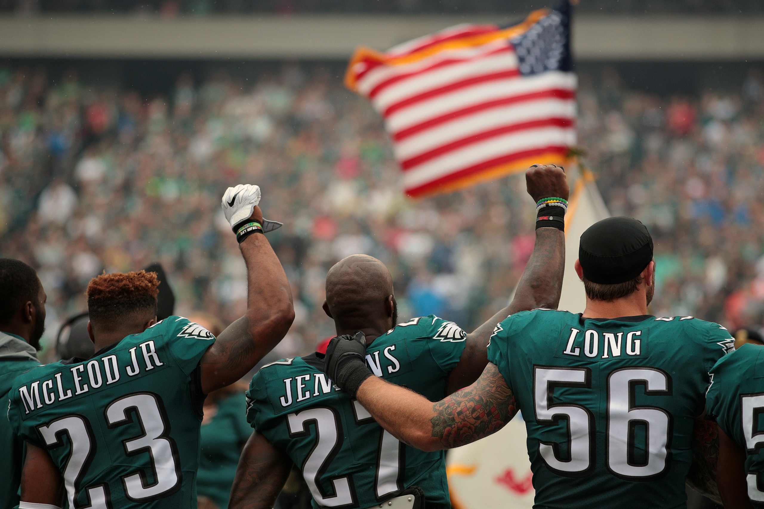 PHILADELPHIA, PA - OCTOBER 08: Rodney McLeod #23, Malcolm Jenkins #27 of the Philadelphia Eagles raise their fists in protest during the playing of the National Anthem as teammate Chris Long #56 shows support before a game against the Arizona Cardinals at