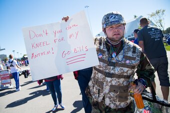 ORCHARD PARK, NY - SEPTEMBER 25:  A fan holds a sign protesting the kneeling by players during the national anthem before the game between the Buffalo Bills and the Arizona Cardinals on September 25, 2016 at New Era Field in Orchard Park, New York. Buffal