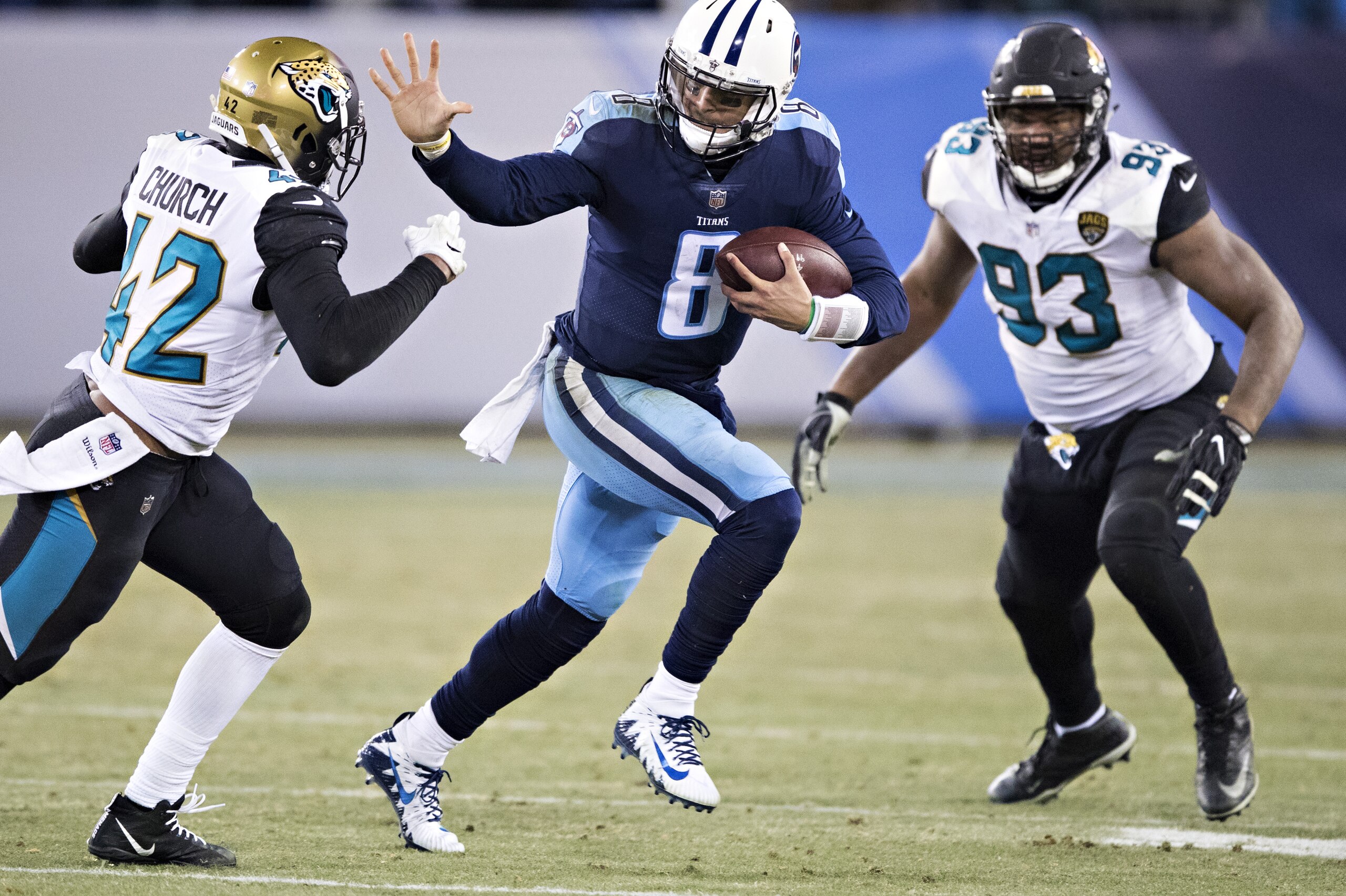 NASHVILLE, TN - DECEMBER 31: Marcus Mariota #8 of the Tennessee Titans runs the ball and stiff arms Barry Church #42 of the Jacksonville Jaguars at Nissan Stadium on December 31, 2017 in Nashville, Tennessee. The Titans defeated the Jaguars 15-10. (Pho NASHVILLE, TN - DECEMBER 31: Marcus Mariota #8 of the Tennessee Titans runs the ball and stiff arms Barry Church #42 of the Jacksonville Jaguars at Nissan Stadium on December 31, 2017 in Nashville, Tennessee. The Titans defeated the Jaguars 15-10. (Pho