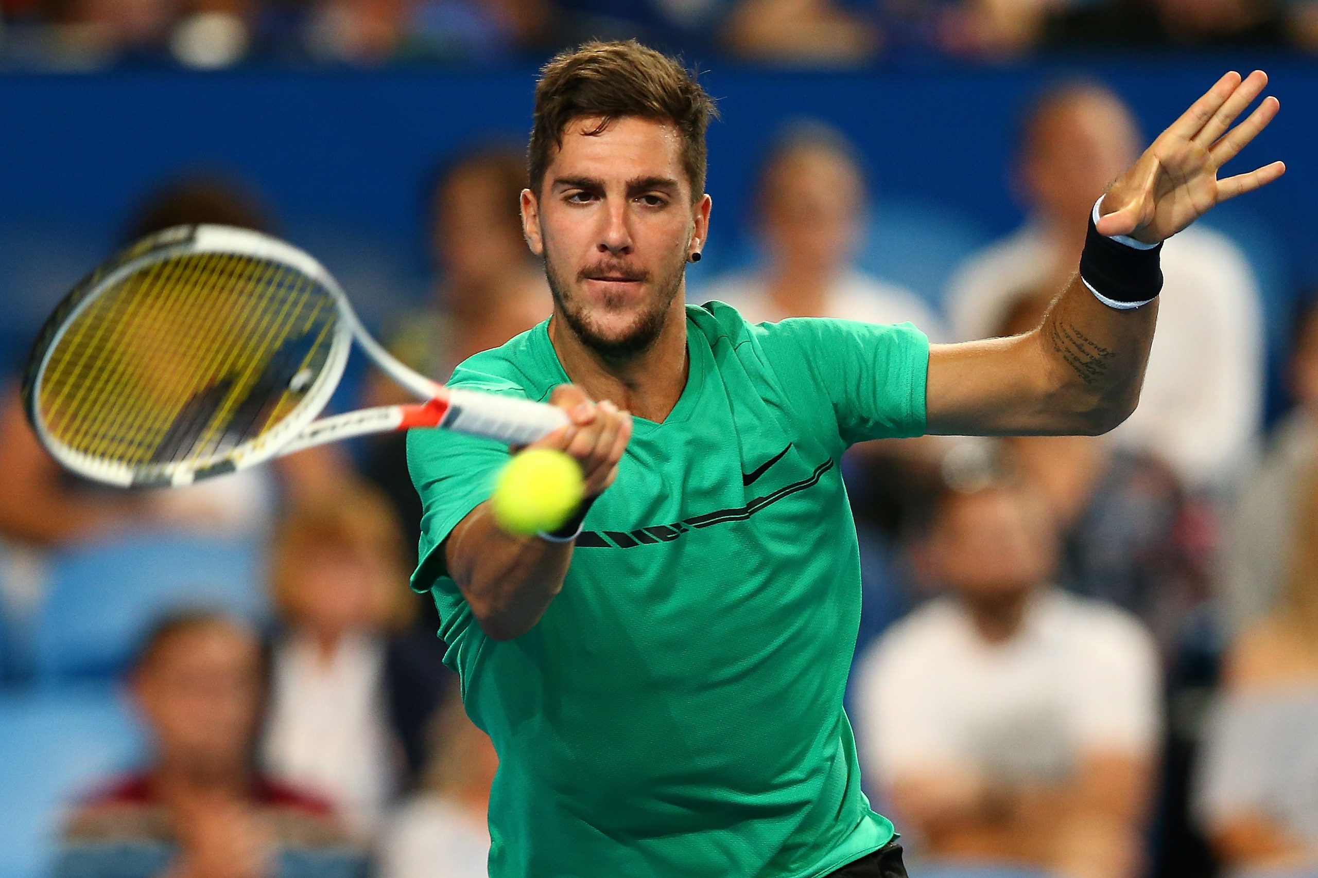 PERTH, AUSTRALIA - JANUARY 03:  Thanasi Kokkinakis of Australia plays a forehand in the mixed doubles match against Elise Mertens and David Goffin of Belgium on day five of the 2018 Hopman Cup at Perth Arena on January 3, 2018 in Perth, Australia.  (Photo