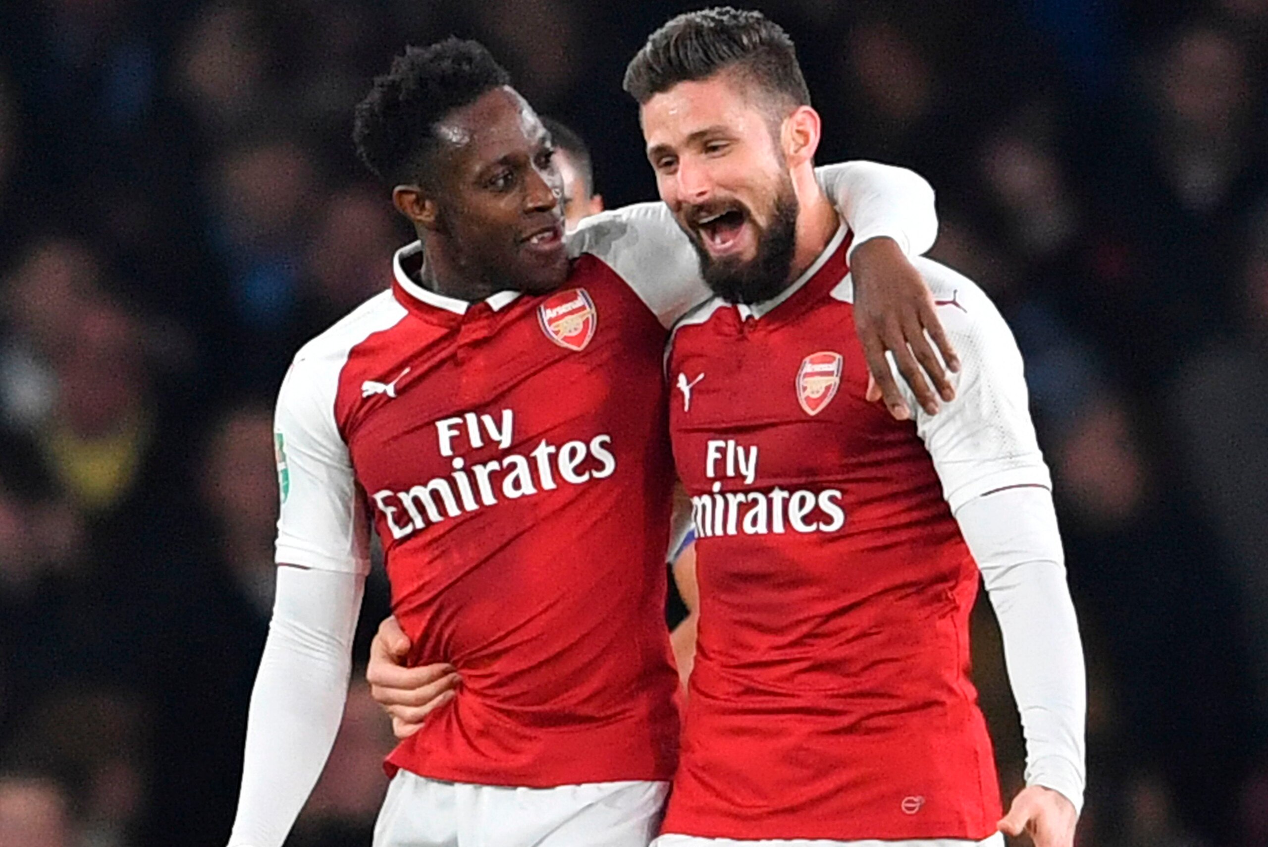 Arsenal's English striker Danny Welbeck (L) celebrates scoring the opening goal with Arsenal's French striker Olivier Giroud (R) during the English League Cup quarter-final football match between Arsenal and West Ham United at the Emirates Stadium in Lond