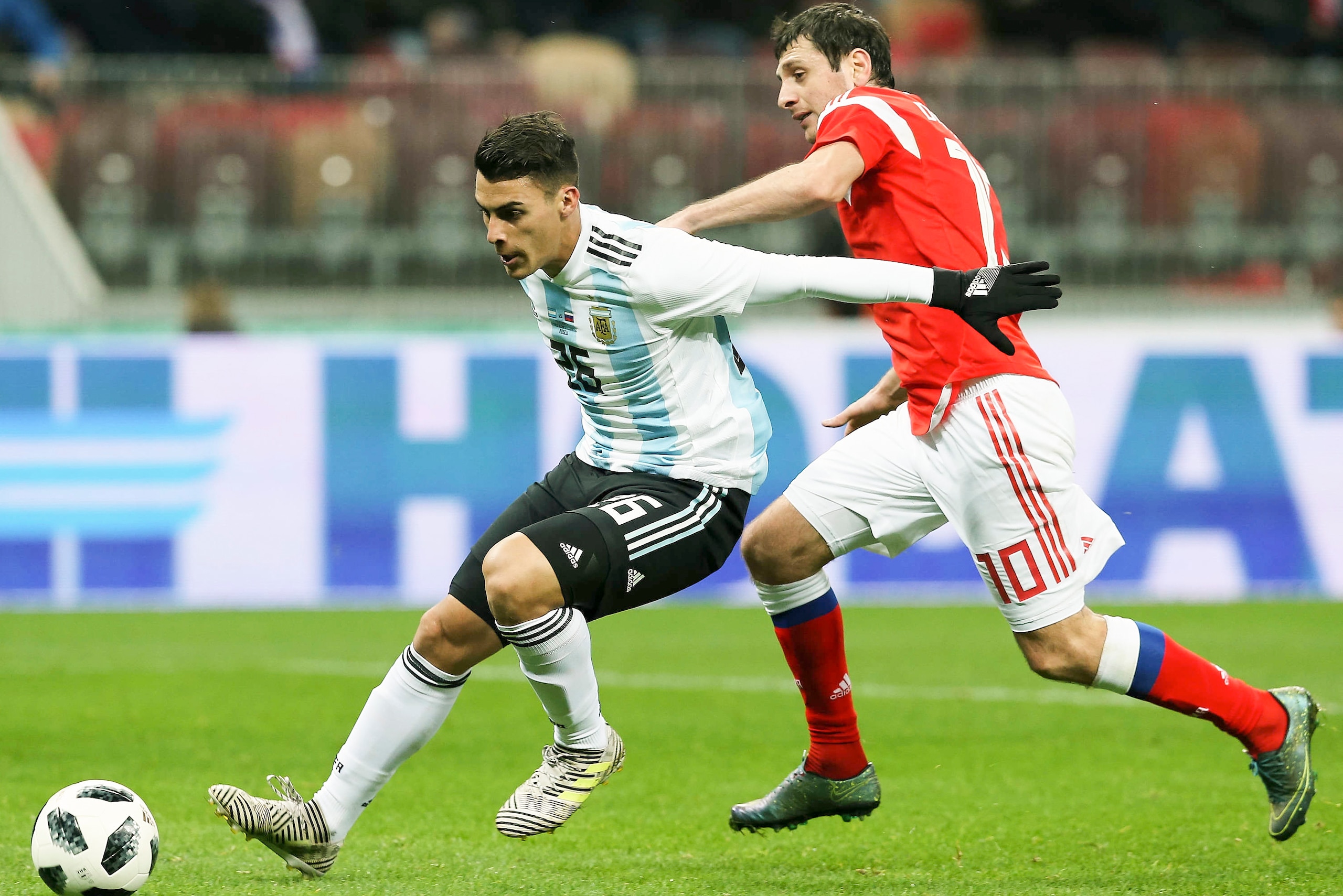 MOSCOW, RUSSIA - NOVEMBER 11: Alan Dzagoev of Russia vies for the ball with Cristian Pavon of Argentina during an international friendly match between Russia and Argentina at Luzhniki Stadium on November 11, 2017 in Moscow, Russia. (Photo by Epsilon/Getty