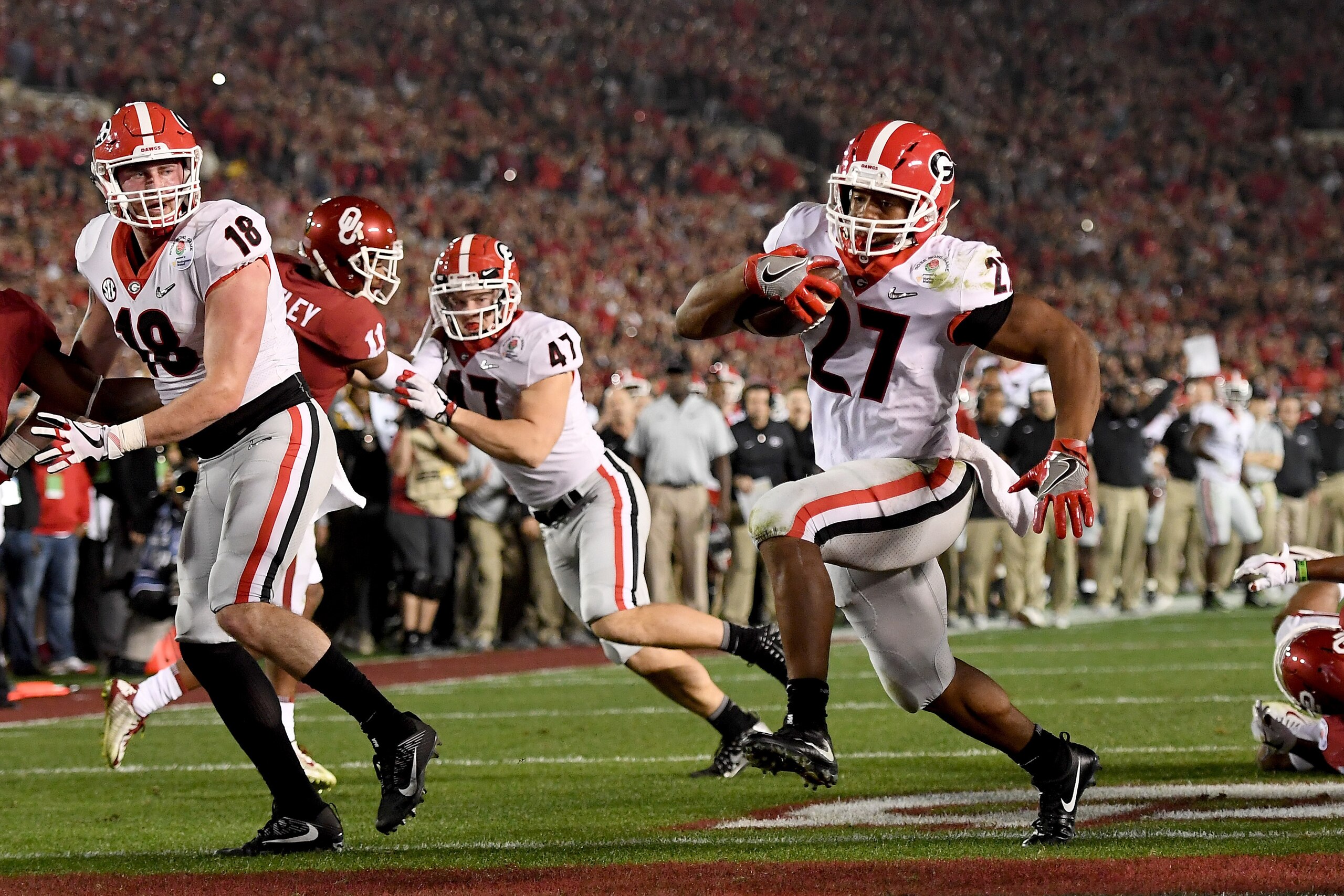 PASADENA, CA - JANUARY 01:  Running back Nick Chubb #27 of the Georgia Bulldogs scores on a two-yard touchdown run late in the fourth quarter against the Oklahoma Sooners in the 2018 College Football Playoff Semifinal at the Rose Bowl Game presented by No