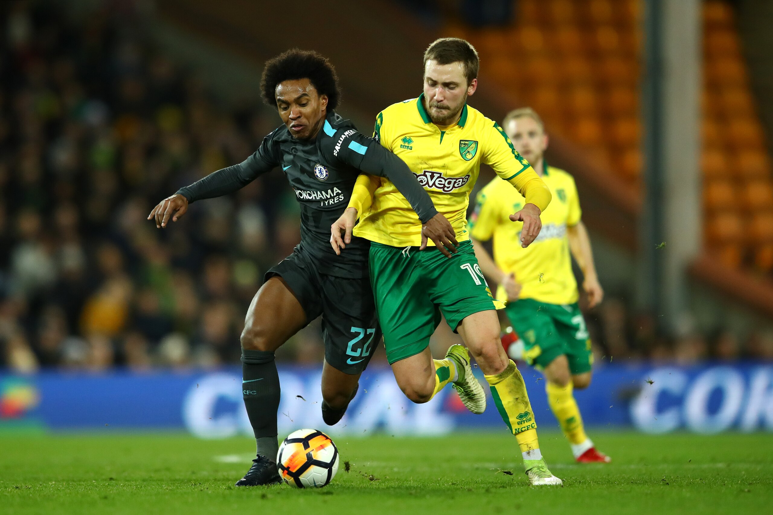 NORWICH, ENGLAND - JANUARY 06:  Willian of Chelsea challenges Tom Trybull of Norwich City during the Emirates FA Cup Third Round match between Norwich City and Chelsea at Carrow Road on January 6, 2018 in Norwich, England.  (Photo by Clive Mason/Getty Ima