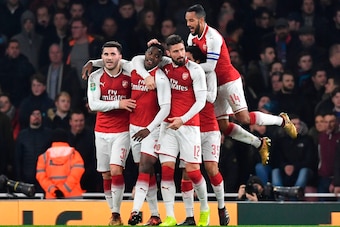 Arsenal's English striker Danny Welbeck (2L) celebrates scoring the opening goal with team-mates Arsenal's German-born Bosnian defender Sead Kolasinac (L), Arsenal's French striker Olivier Giroud (3R) and Arsenal's English midfielder Theo Walcott (R) duri