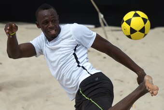 Usain Bolt, the two-time reigning Olympic champion over 100 and 200m, plays foovolley at Copacabana beach in Rio de Janeiro, Brazil on March 30, 2013. Bolt will bid to better his world record over the rarely-raced distance of 150 metres on Rio de Janeiro'