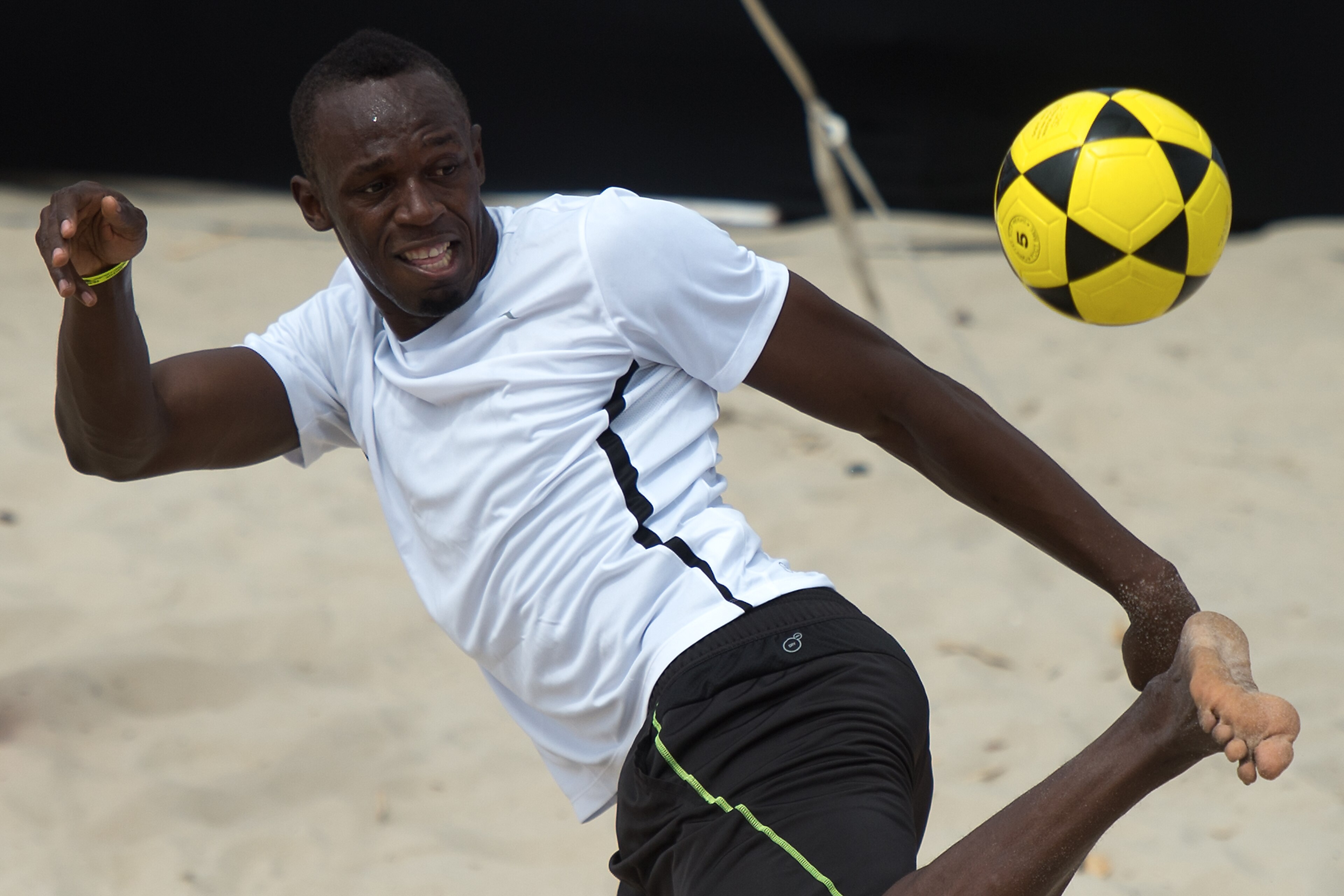 Usain Bolt, the two-time reigning Olympic champion over 100 and 200m, plays foovolley at Copacabana beach in Rio de Janeiro, Brazil on March 30, 2013. Bolt will bid to better his world record over the rarely-raced distance of 150 metres on Rio de Janeiro' Usain Bolt, the two-time reigning Olympic champion over 100 and 200m, plays foovolley at Copacabana beach in Rio de Janeiro, Brazil on March 30, 2013. Bolt will bid to better his world record over the rarely-raced distance of 150 metres on Rio de Janeiro'