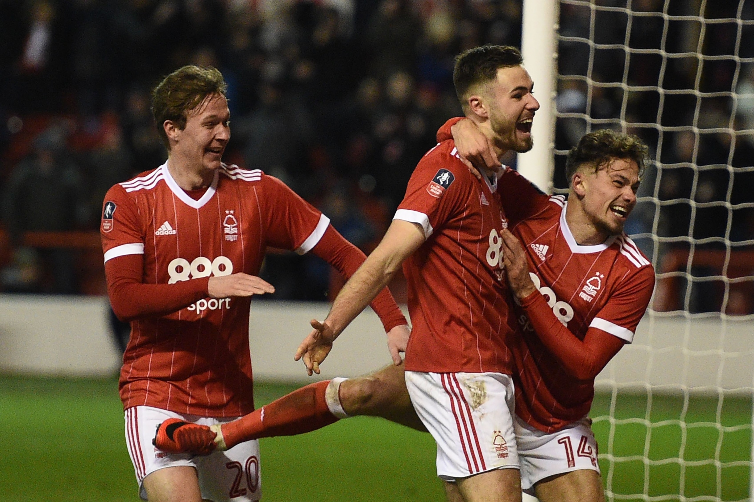 Nottingham Forest's English midfielder Kieran Dowell (L), Nottingham Forest's English striker Ben Brereton (C) and Nottingham Forest's English midfielder Matty Cash celebrate Brereton's penalty during the English FA Cup third round football match between 