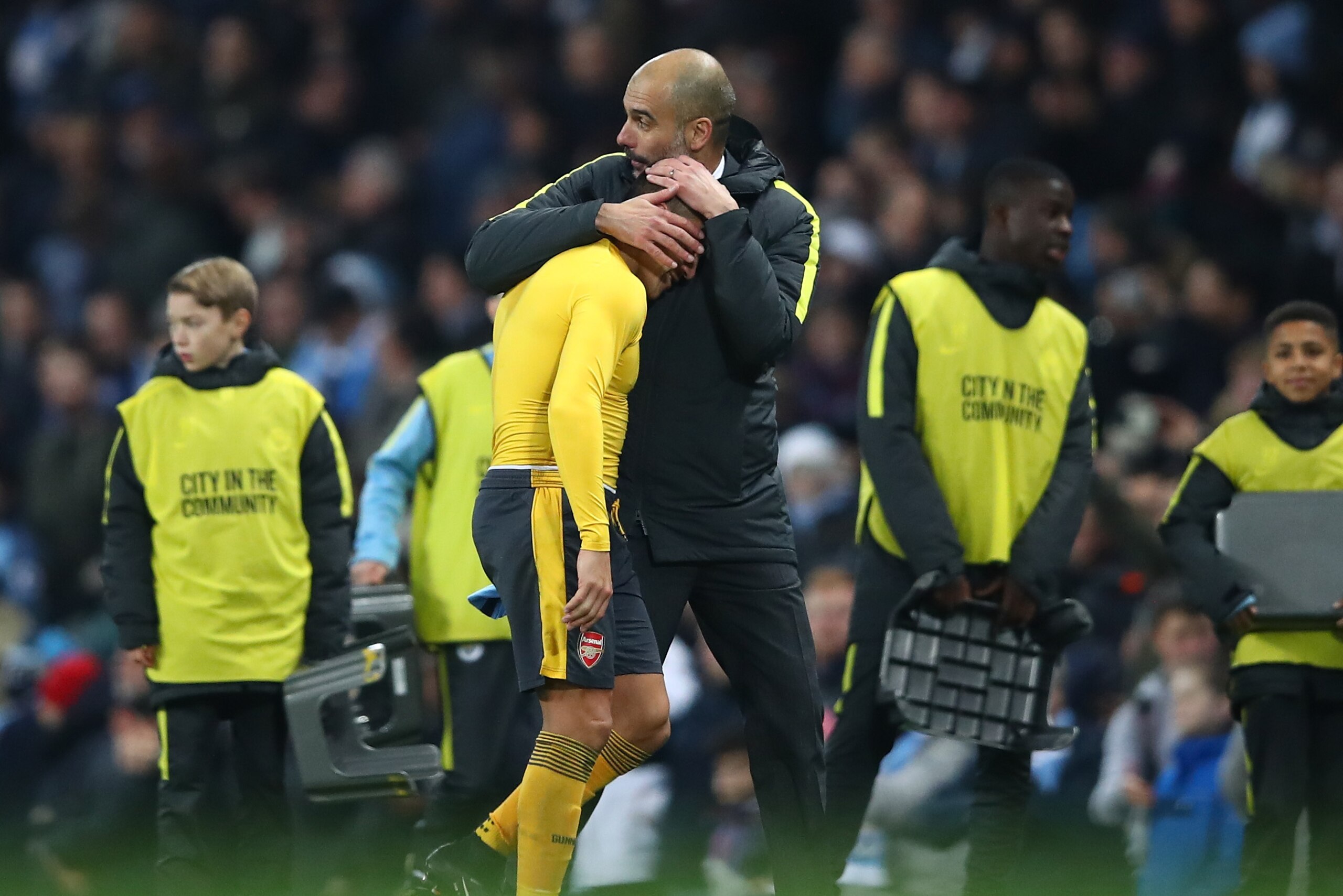MANCHESTER, ENGLAND - DECEMBER 18: Alexis Sanchez of Arsenal (L) and Josep Guardiola, Manager of Manchester City (R) embrace after the final whistle during the Premier League match between Manchester City and Arsenal at the Etihad Stadium on December 18, MANCHESTER, ENGLAND - DECEMBER 18: Alexis Sanchez of Arsenal (L) and Josep Guardiola, Manager of Manchester City (R) embrace after the final whistle during the Premier League match between Manchester City and Arsenal at the Etihad Stadium on December 18,