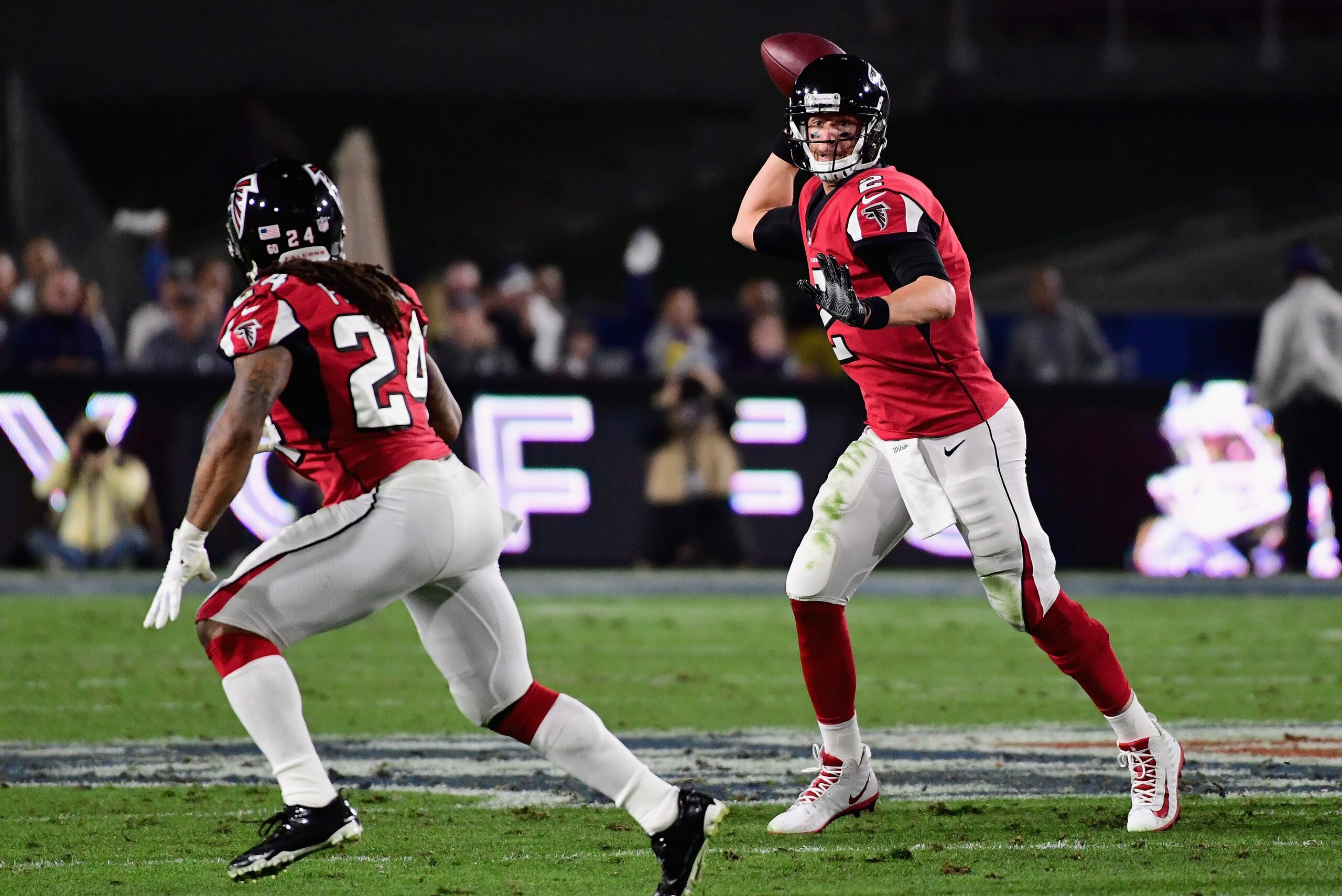 LOS ANGELES, CA - JANUARY 06:  Quarterback Matt Ryan #2 of the Atlanta Falcons prepares to pass to running back Devonta Freeman #24 during the first quarter of the NFC Wild Card Playoff game against the Los Angeles Rams at Los Angeles Coliseum on January 