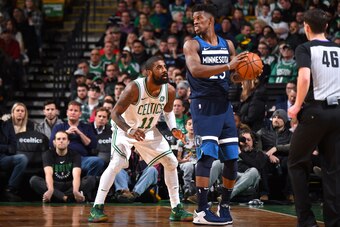 BOSTON, MA - JANUARY 5:  Jimmy Butler #23 of the Minnesota Timberwolves handles the ball against Kyrie Irving #11 of the Boston Celtics on January 5, 2018 at the TD Garden in Boston, Massachusetts. NOTE TO USER: User expressly acknowledges and agrees that