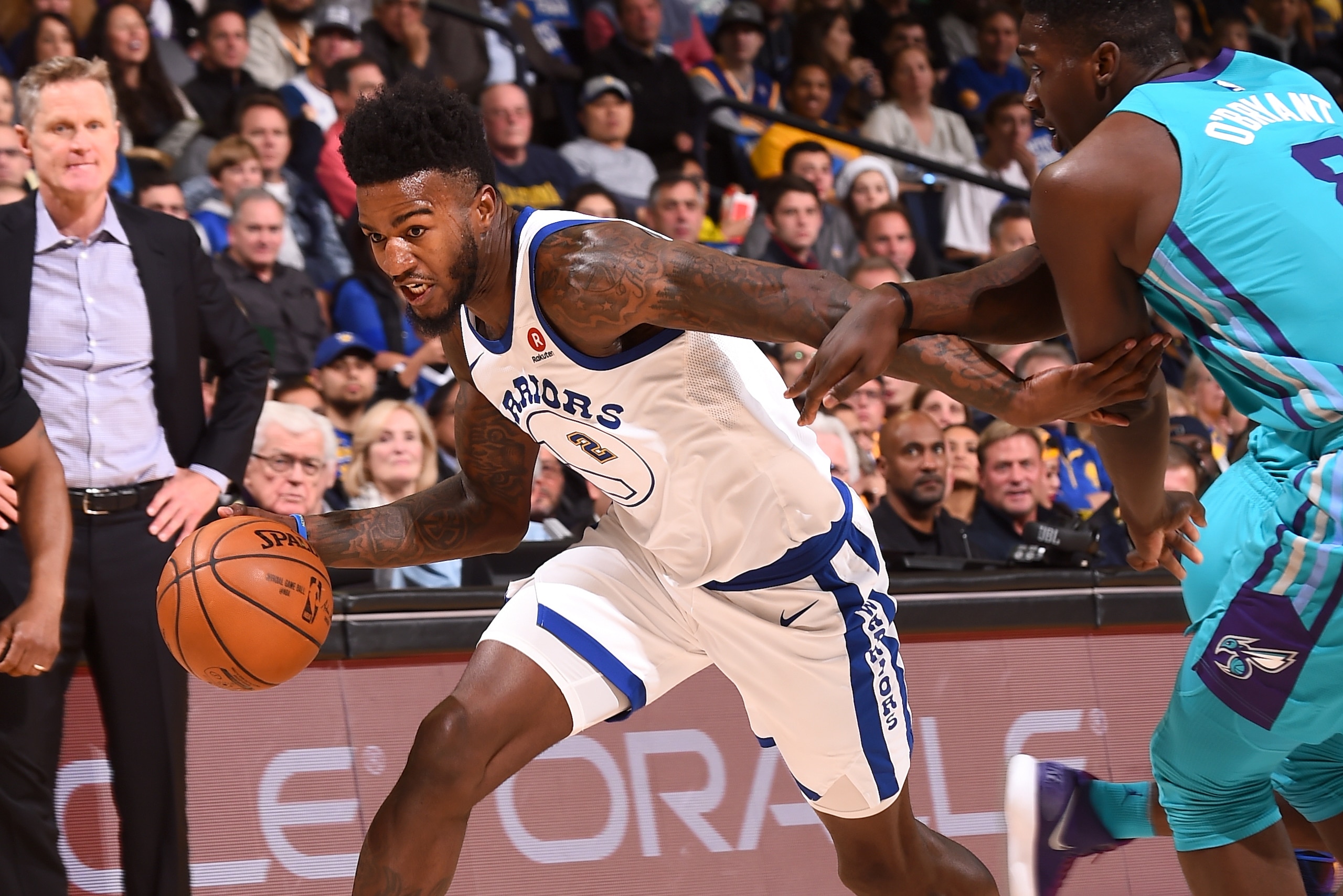 OAKLAND, CA - DECEMBER 29:  Jordan Bell #2 of the Golden State Warriors handles the ball against the Charlotte Hornets on December 29, 2017 at ORACLE Arena in Oakland, California. NOTE TO USER: User expressly acknowledges and agrees that, by downloading a