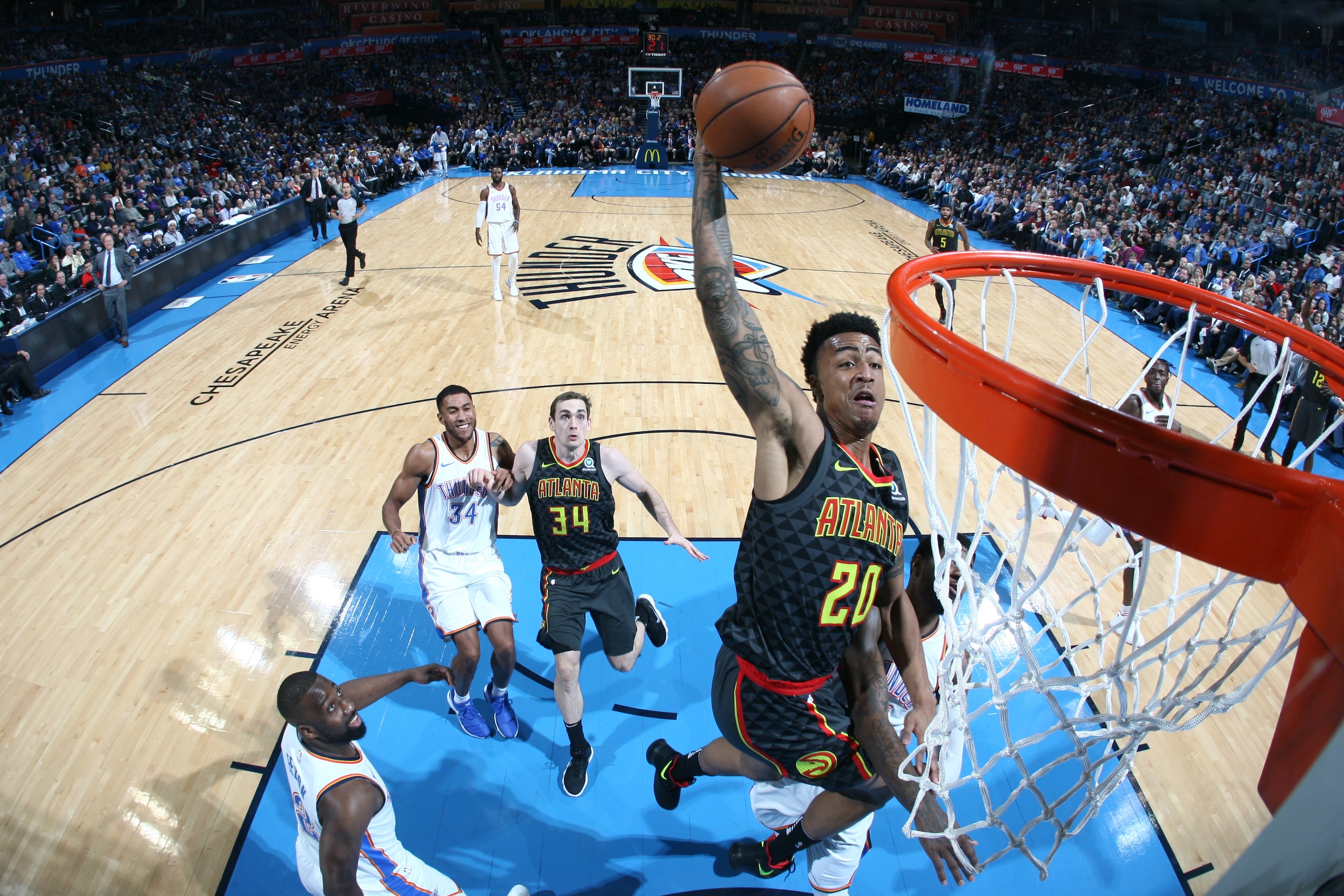 OKLAHOMA CITY, OK - DECEMBER 22:  John Collins #20 of the Atlanta Hawks dunks against the Oklahoma City Thunder on December 22, 2017 at Chesapeake Energy Arena in Oklahoma City, Oklahoma. NOTE TO USER: User expressly acknowledges and agrees that, by downl