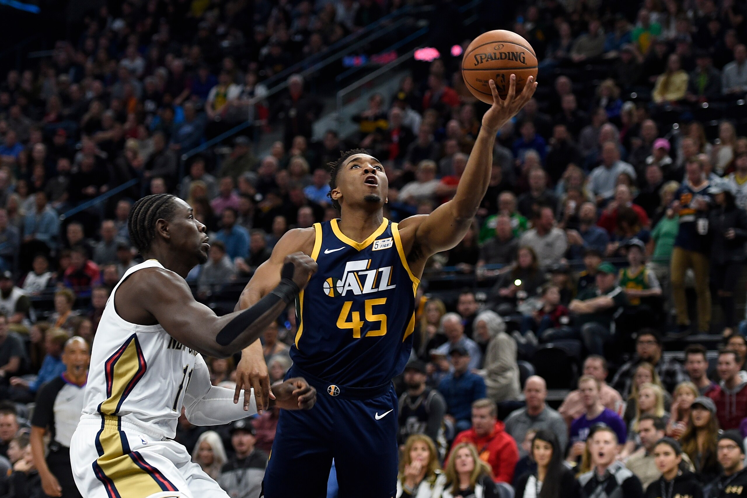 SALT LAKE CITY, UT - JANUARY 03: Donovan Mitchell #45 of the Utah Jazz shoots the ball while being defended by Jrue Holiday #11 of the New Orleans Pelicans during their game at Vivint Smart Home Arena on January 3, 2018 in Salt Lake City, Utah. NOTE TO US