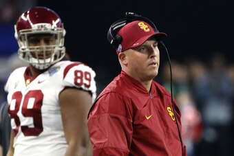 ARLINGTON, TX - DECEMBER 29: Head coach Clay Helton and Austin Applebee #89 of the USC Trojans look toward the field in the first half of the 82nd Goodyear Cotton Bowl Classic between USC and Ohio State at AT&T Stadium on December 29, 2017 in Arlington, T