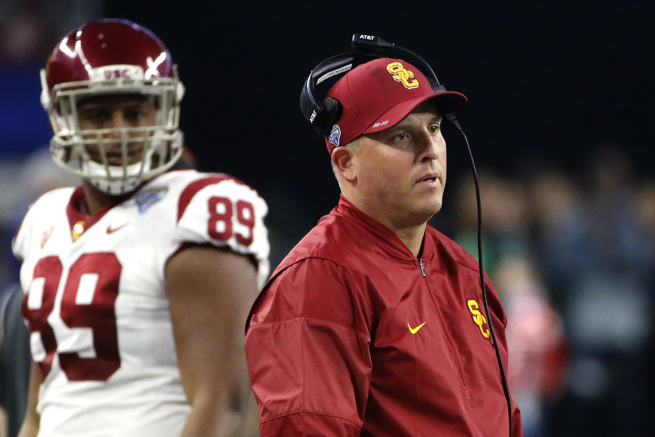 ARLINGTON, TX - DECEMBER 29: Head coach Clay Helton and Austin Applebee #89 of the USC Trojans look toward the field in the first half of the 82nd Goodyear Cotton Bowl Classic between USC and Ohio State at AT&T Stadium on December 29, 2017 in Arlington, T