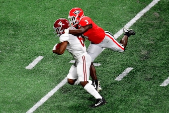 ATLANTA, GA - JANUARY 08:  Josh Jacobs #8 of the Alabama Crimson Tide is tackled by Roquan Smith #3 of the Georgia Bulldogs after a catch during the first quarter in the CFP National Championship presented by AT&T at Mercedes-Benz Stadium on January 8, 20