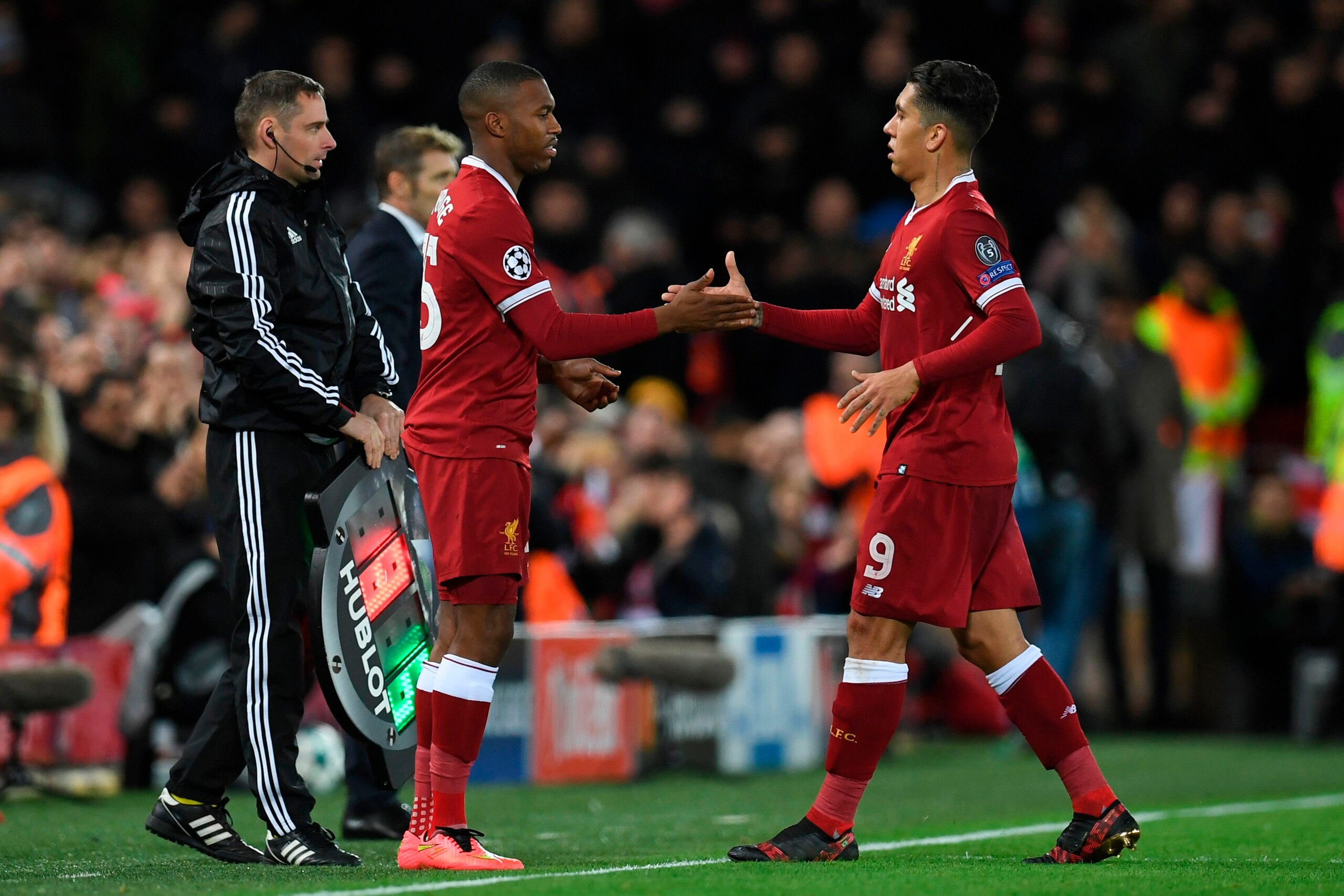 Liverpool's Brazilian midfielder Roberto Firmino (R) shakes hands with Liverpool's English striker Daniel Sturridge (L) as Firmino is substituted during the UEFA Champions League Group E football match between Liverpool and Spartak Moscow at Anfield in Li